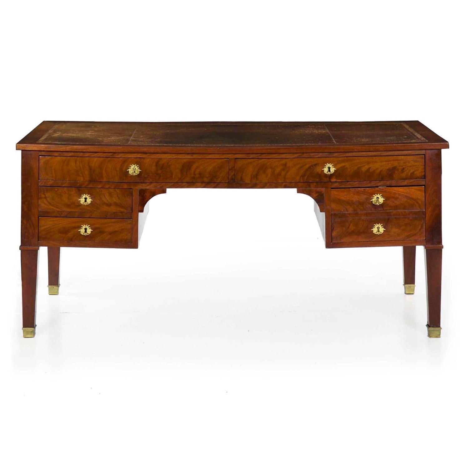 An incredibly fine presentation piece crafted of the finest materials, this gorgeous French neoclassical writing desk is a vivid strikepoint. Dressed in choice selections of flamed mahogany, the veneers are laid out with precision in a way that