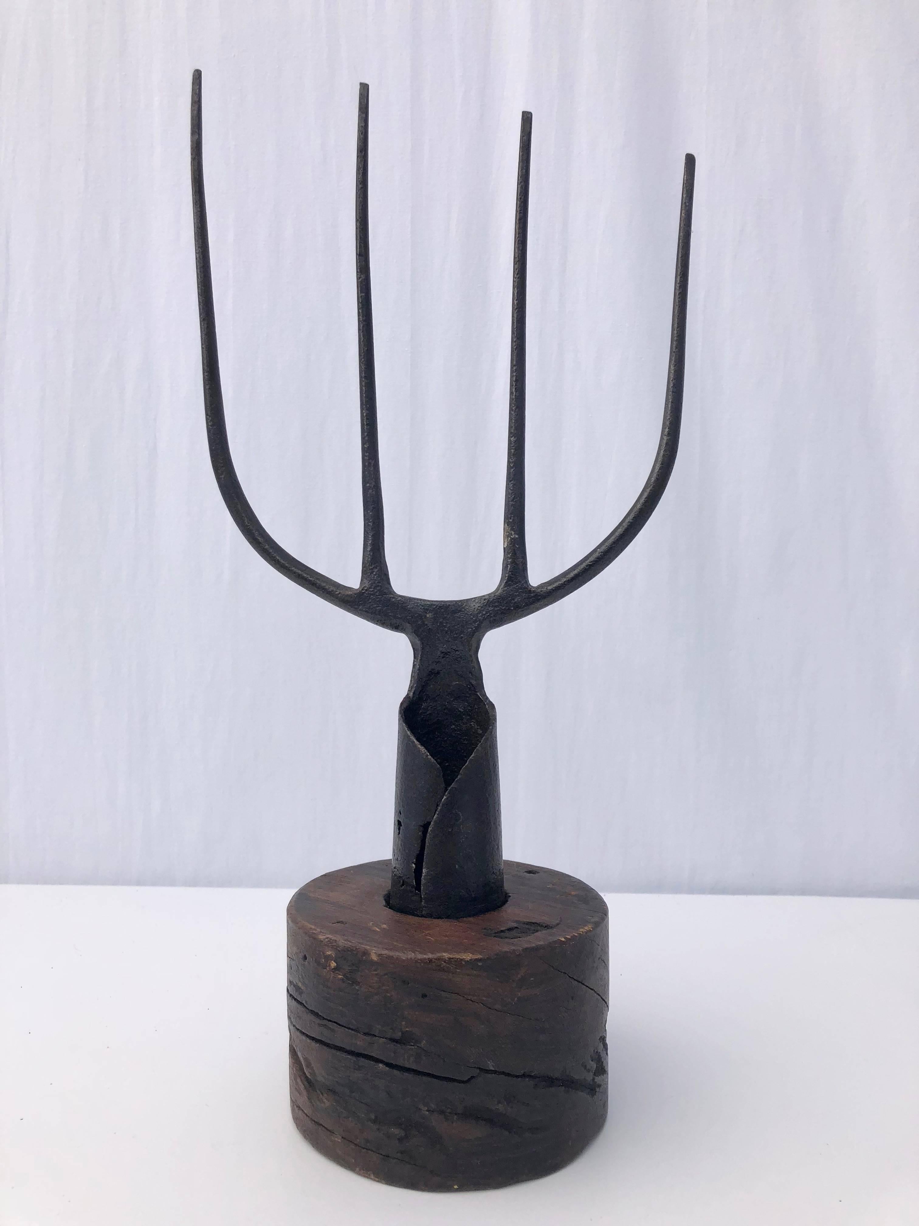 This French antique wrought iron farmer's fork on a wooden pedestal is a very unique decorative item.
The hand forged fork is asymmetrical and could also be used for a variety of different purposes, adding a 1700s French touch.