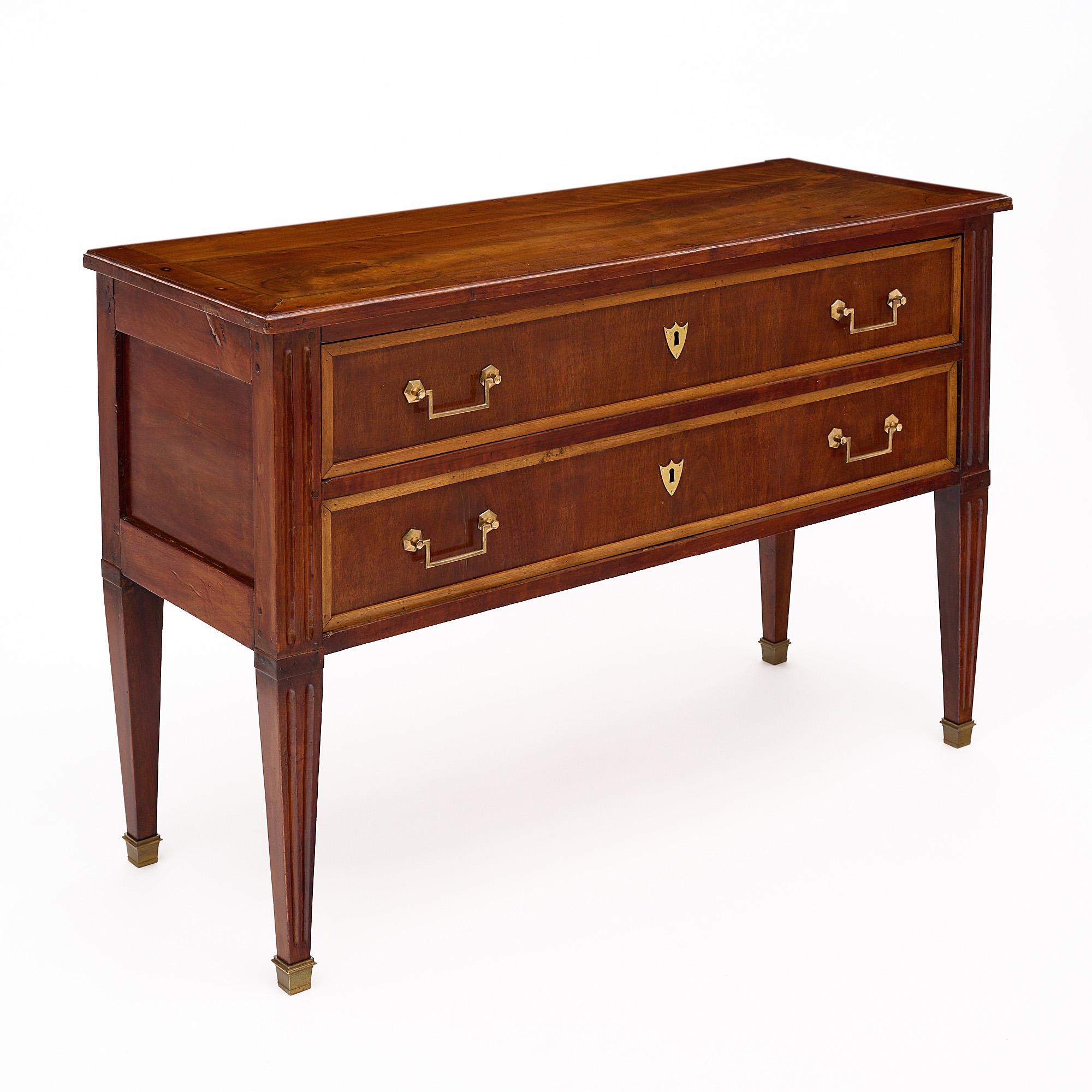 This French antique chest of drawers embodies the timeless elegance of the Louis XVI style and originates from the enchanting Rhone Valley. Carefully crafted, it highlights the stunning beauty of cherrywood and tinted cherrywood, skillfully joined