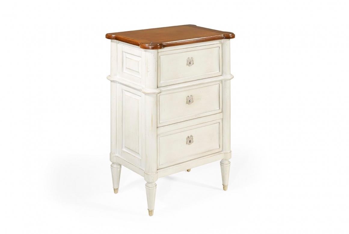 A stunning French Antoinette Louis XVI bedside table, 20th century.

The Antoinette bedside table is shown in cherry wood with washed white finish and a honeycomb top. It has three large drawers and fluted Louis XVI legs.

· Handcrafted in