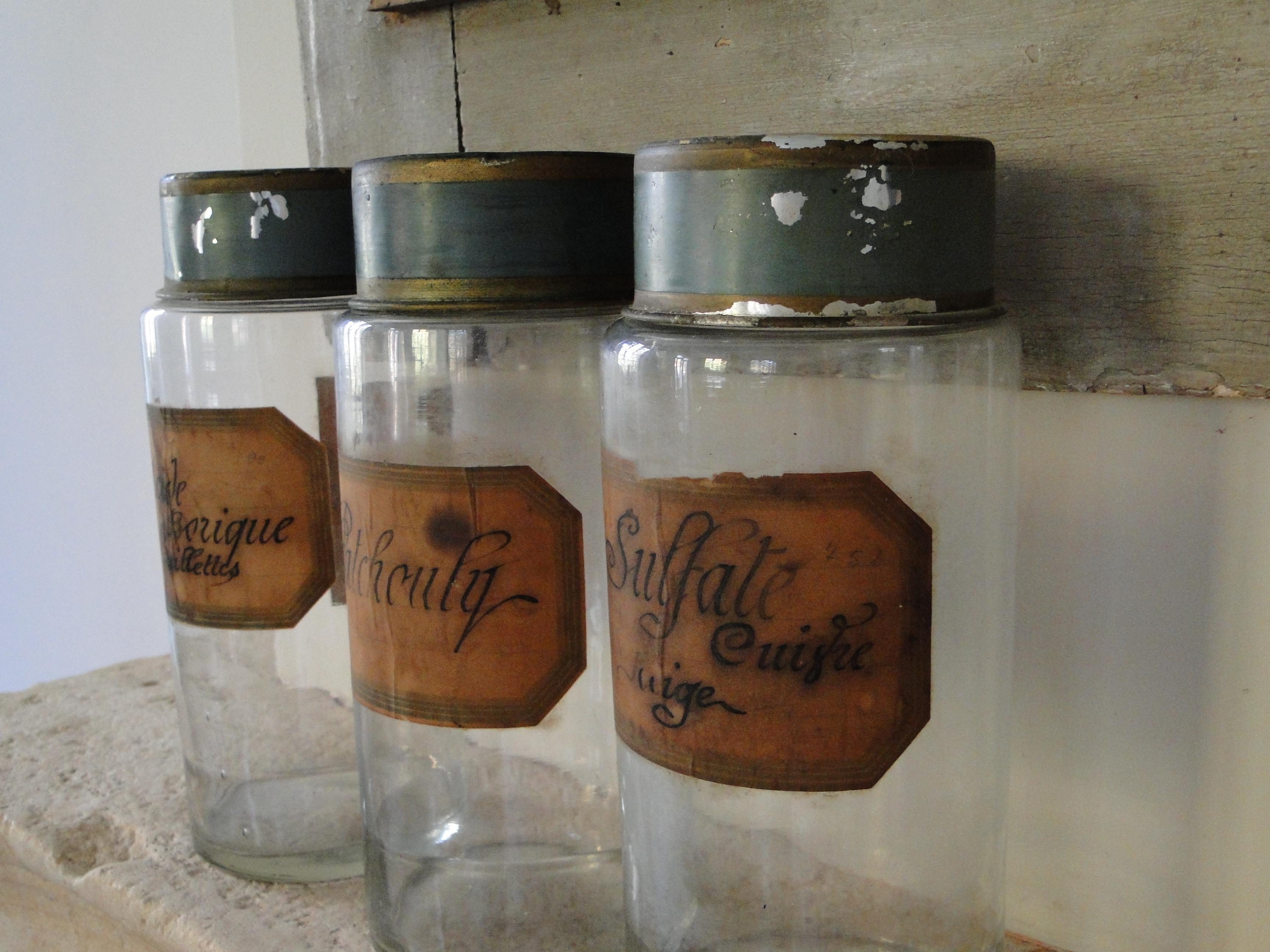 French apothecary glass jars with their handwritten label and painted tin lid.