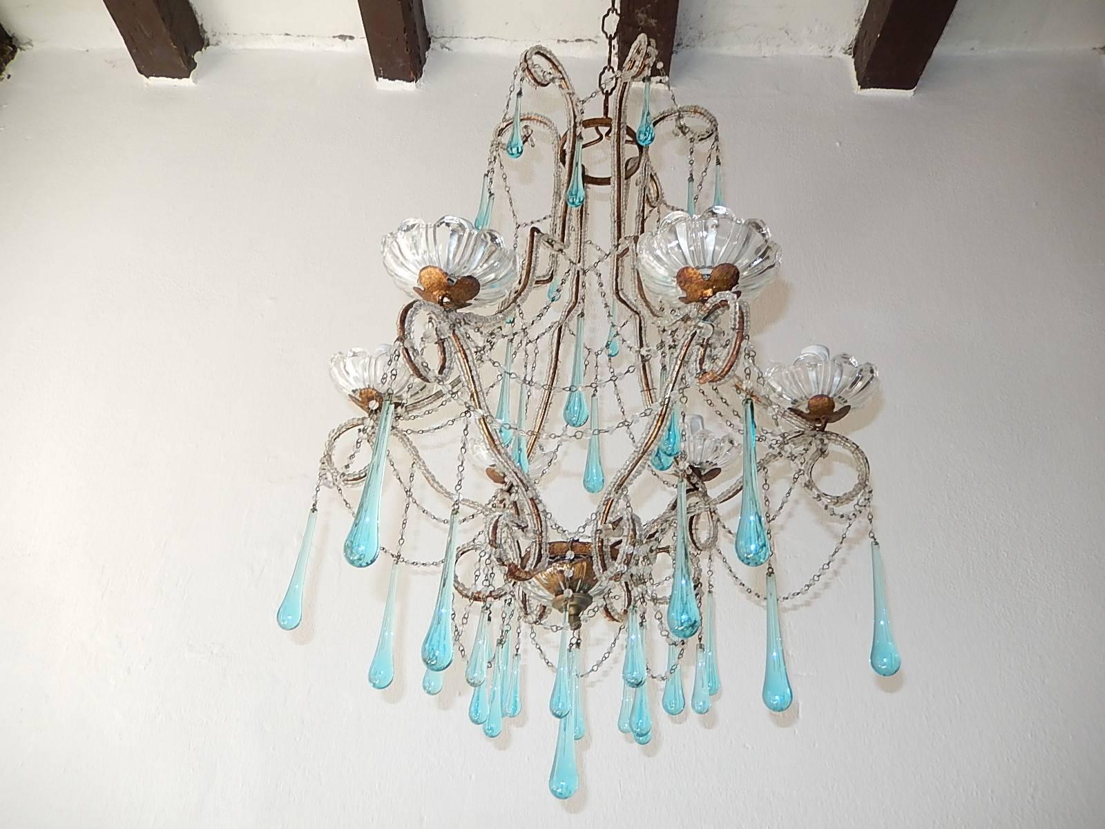 Housing six lights, sitting in crystal bobèches. Will be rewired with certified US UL sockets for the USA and appropriate sockets for all other countries and ready to hang!  Double beaded throughout with different sizes of aqua blue Murano drops.