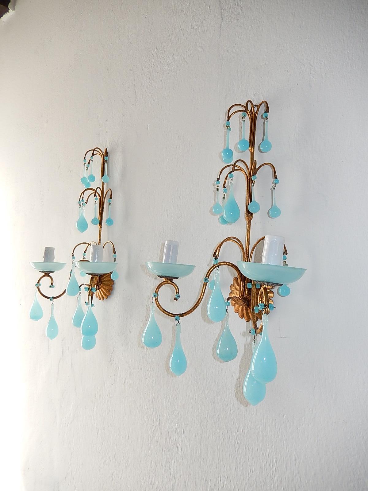 Housing two lights each, sitting in blue opaline bobéches. Adorning blue opaline Murano drops and beads. Re-wired and ready to hang! Free priority UPS shipping from Italy.
