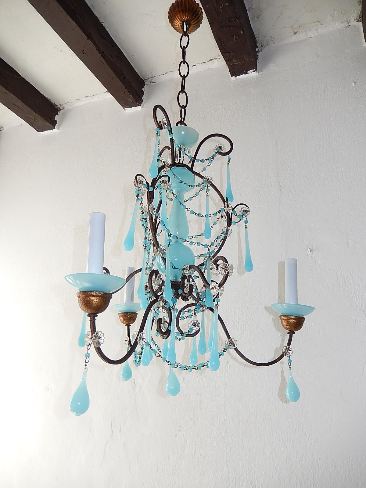 Housing 3-light sitting in blue opaline bobeches on gold gilt posts. Rewired and ready to hang. Adorning swags of blue opaline macaroni beads and drops. Rare Murano glass in center. Florets throughout. Free priority UPS shipping from Italy. Adding