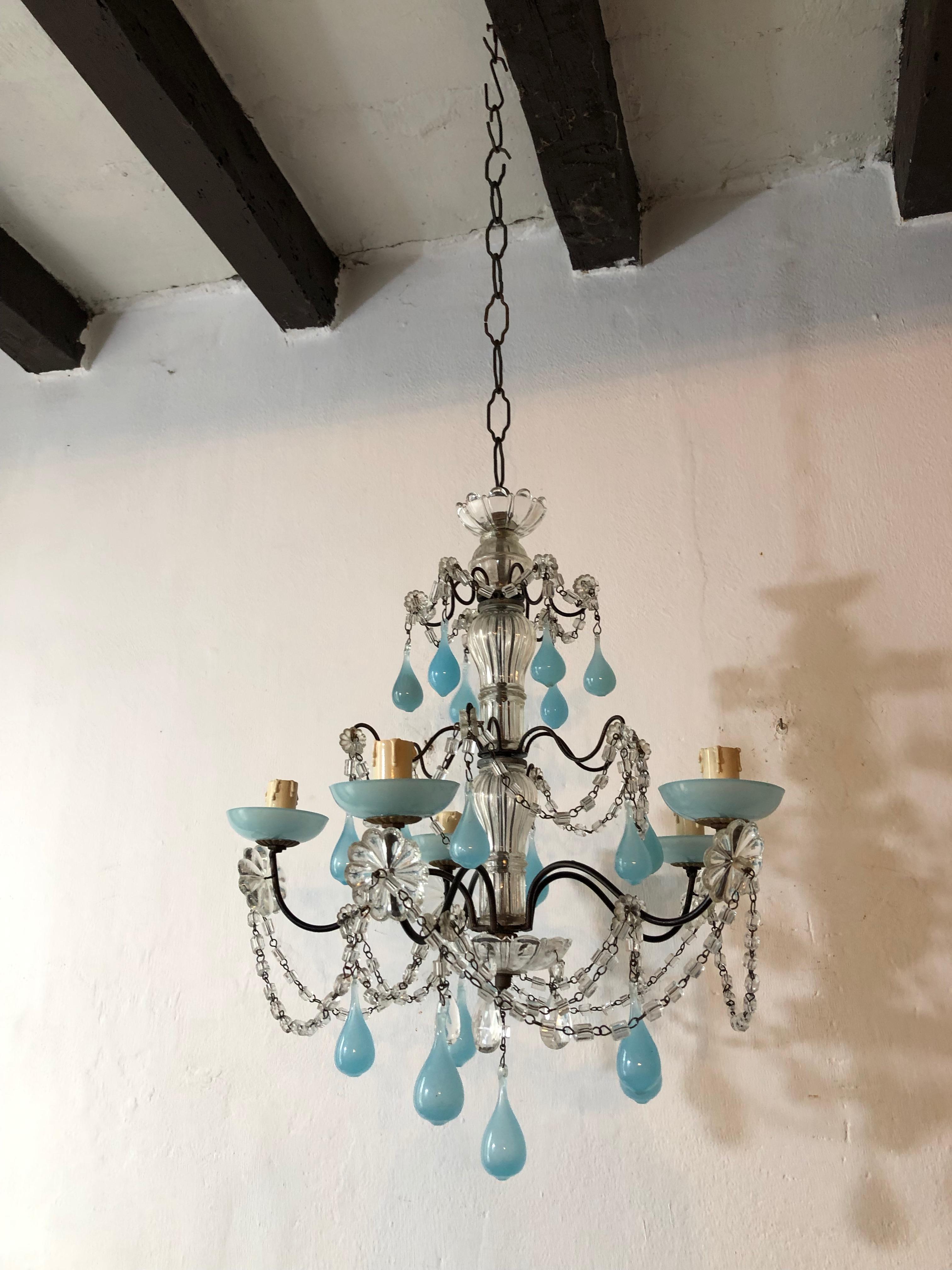 Housing five lights sitting in blue opaline bobeches. Rewired and ready to hang. Two clear crystal bobeches as well. Adorning swags of macaroni beads, florets and rare fat blue opaline Murano glass drops. Free priority shipping from Italy. Adding