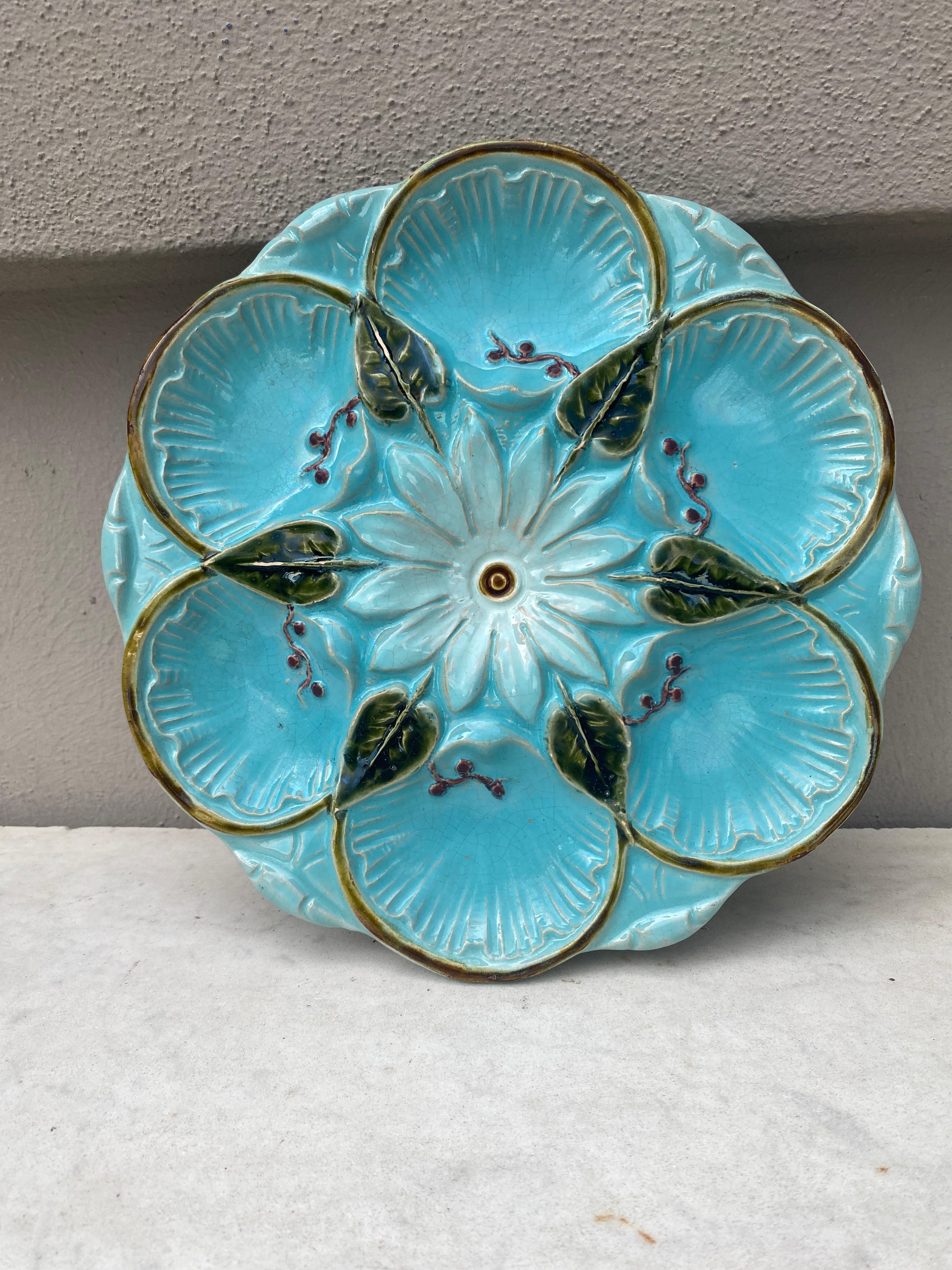Very rare French aqua Majolica oyster plate, circa 1890.
White flower on the center and leaves.