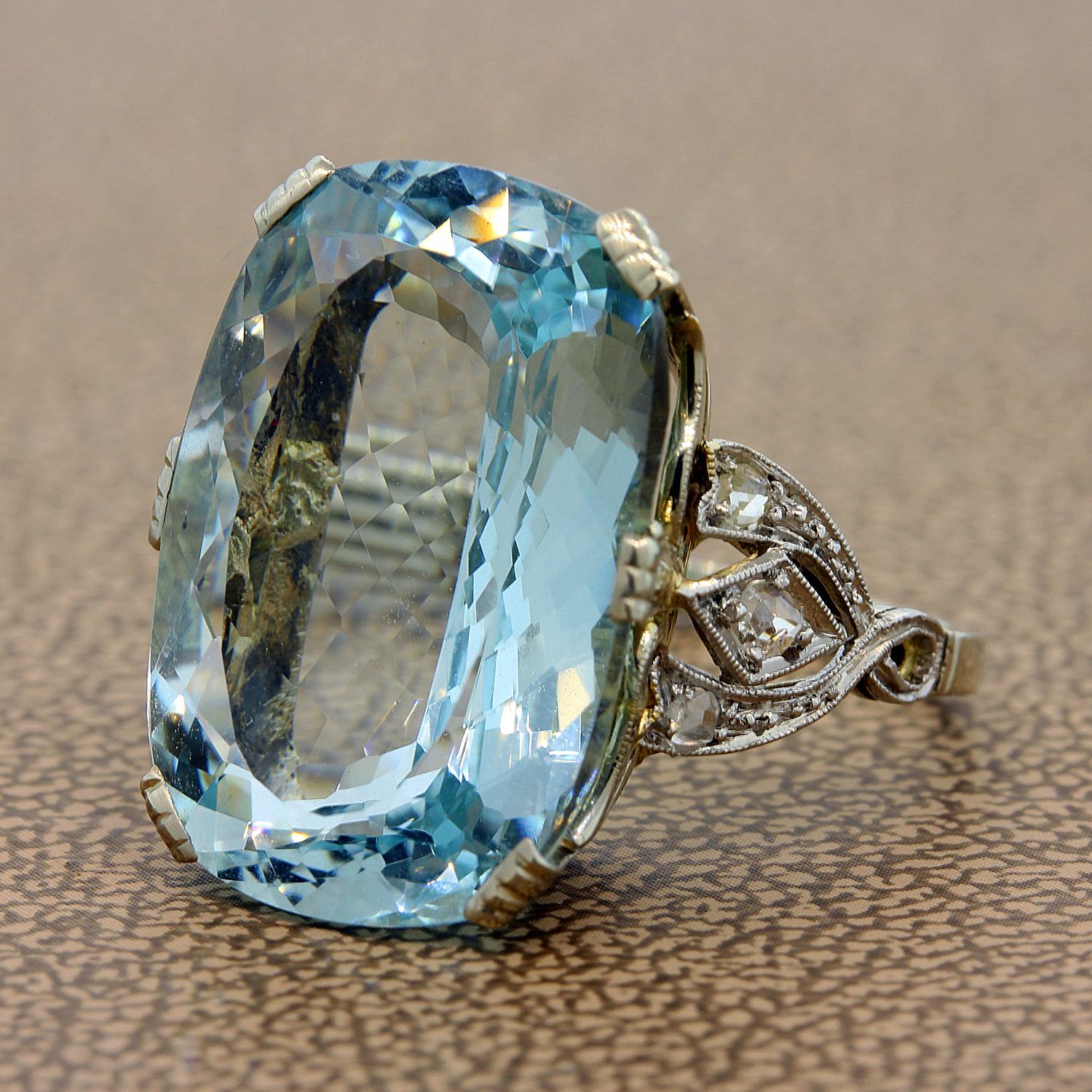 A sophisticated Parisian ring featuring a 12.55 carat aquamarine. The shimmering cushion cut aquamarine is accented by 0.10 carats of round cut diamonds in it 18K white gold filigree setting. 

Ring Size 5.25 (Sizable)

