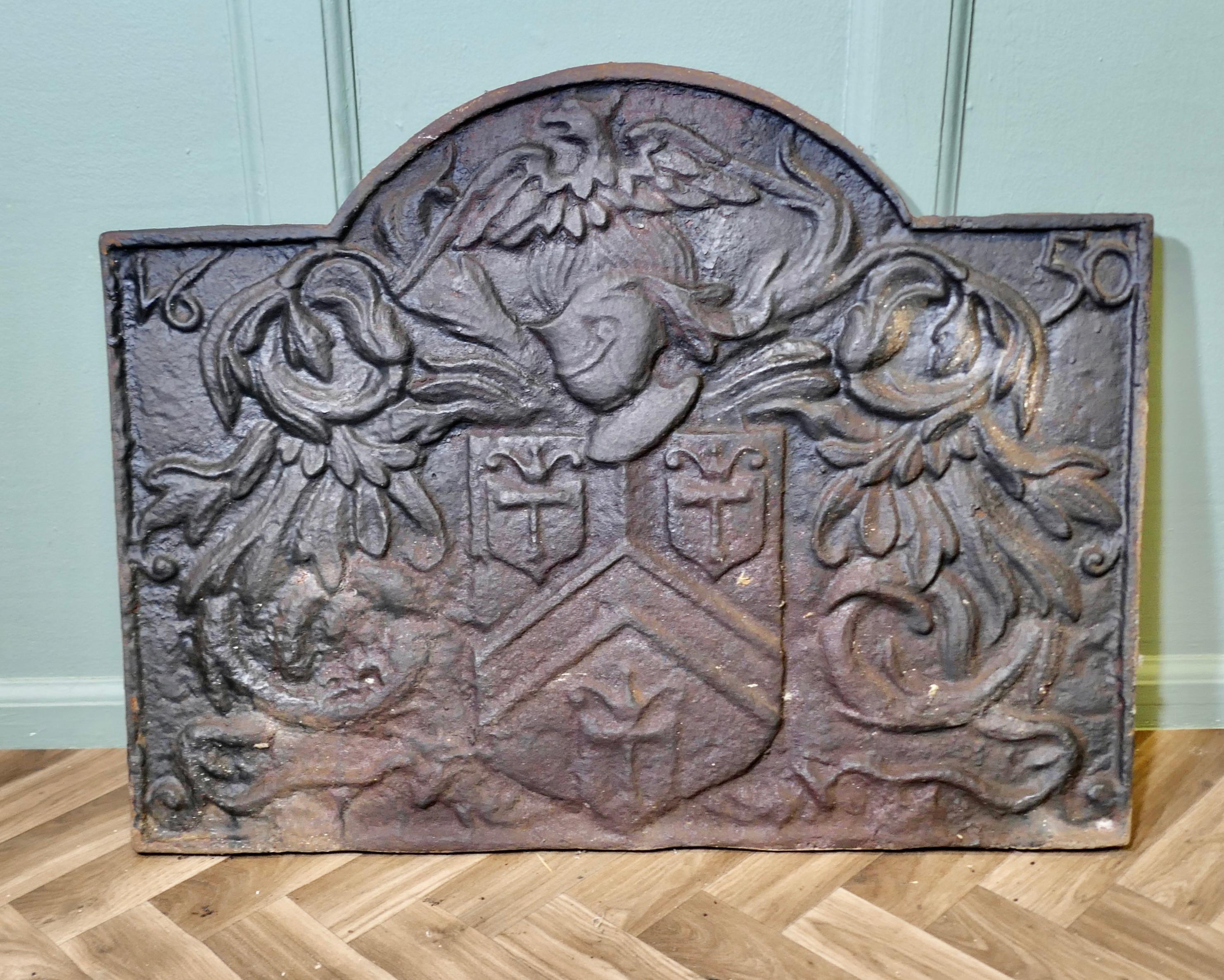 French Arch Top Fire Back. Armour and Eagle

The fire back has a large crest or shield in the centre that is surrounded by leaves and flowers. Above the crest is a helmet from a suit of armour and an eagle or phoenix. The fire back has a shaped top