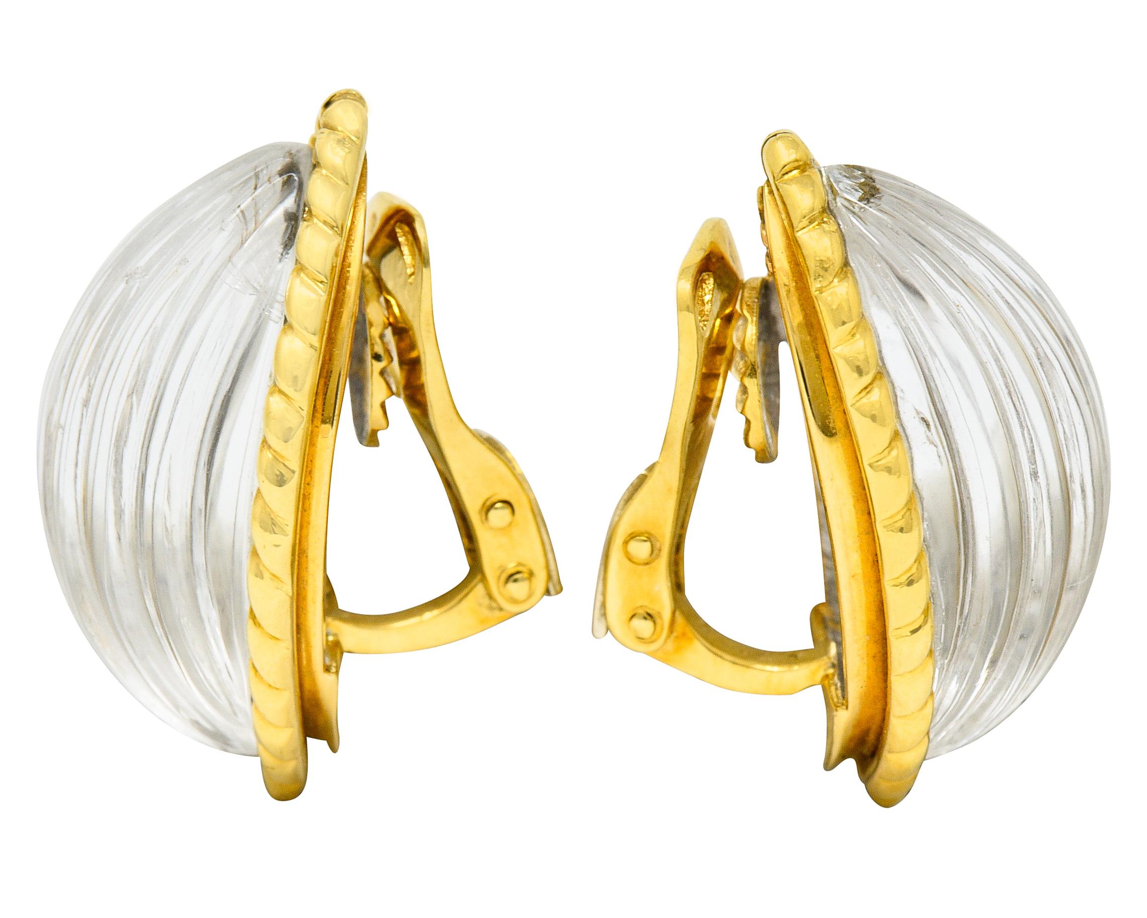 Navette shaped earrings center highly domed rock crystal quartz cabochons

Transparent and deeply carved with a fluted design

Bezel set in a twisted rope surround

Completed by hinged omega backs

French assay marks for 18 karat gold

Fully signed