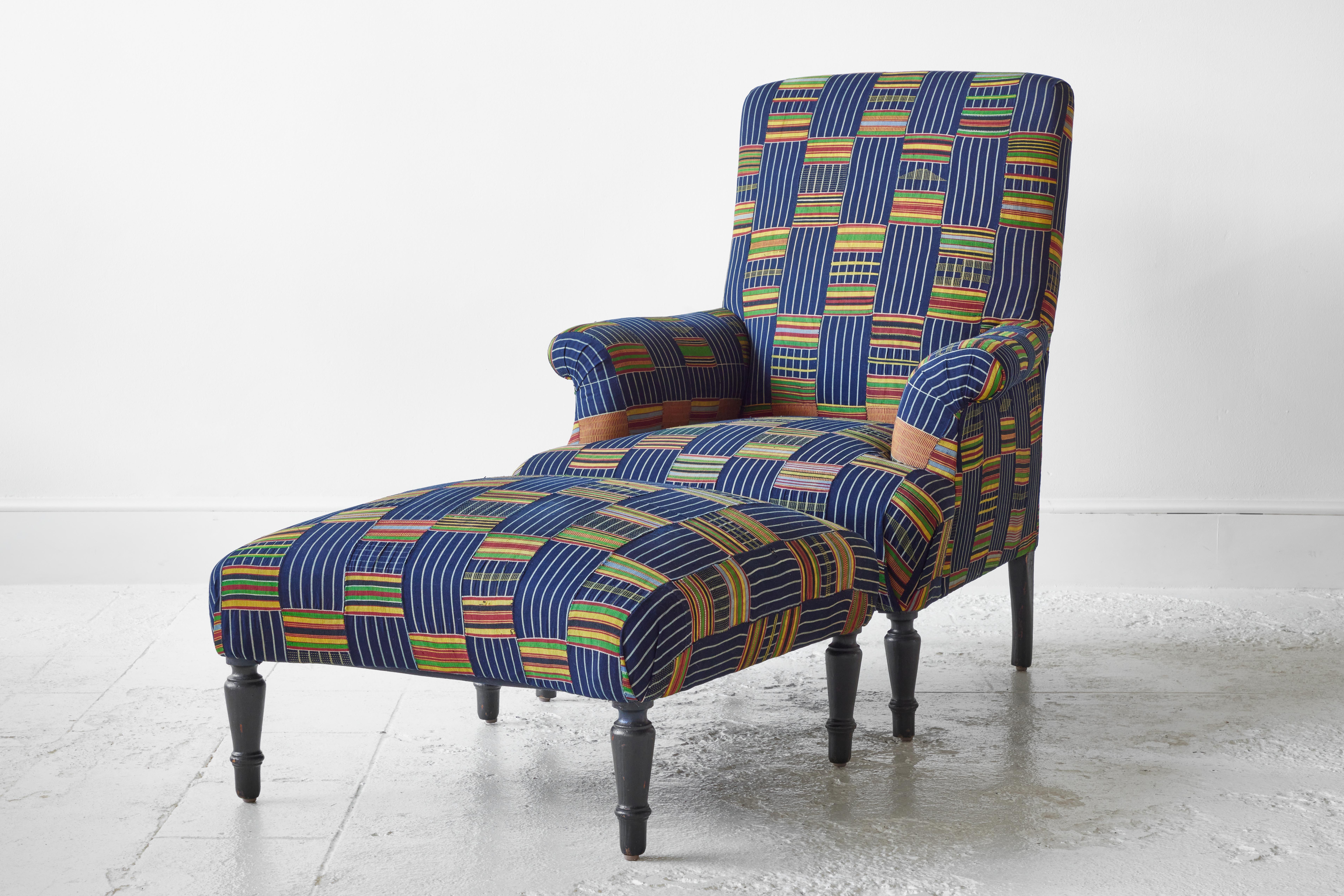 French armchair and ottoman newly upholstered in indigo African Ewe Fabric. The chair and ottoman combination is a beautiful and textural assortment of Classic shapes and color.

Chair measures: 26