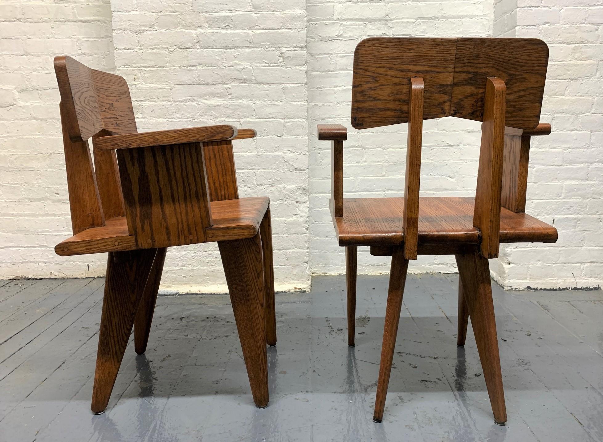 Pair of French armchairs if the manner of Jean Prouvé. Chairs are solid oak. Really nice with unique lines.