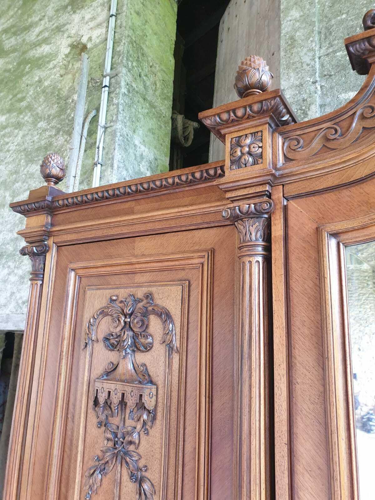 This is an Exceptional Louis XVI revival armoire, carved from a high quality Walnut.
The Wardrobe has a Beautiful Central Crest, Carved with Floral Bouquets 
 and Ribbons. The Elegant armoire has Acorn Carved Finials that provide Provenance and