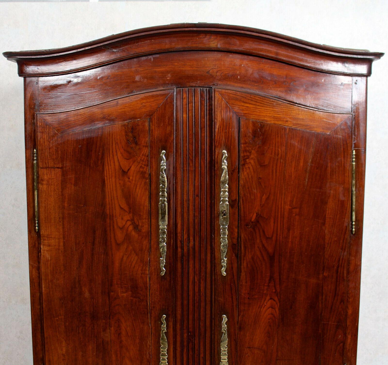 An impressive 19th century French cherrywood armoire.

Beautifully proportioned with a gracefully arched cornice and carved squat cabriole legs. The paneled doors enclosed a hanging rail running the width, shelving and a extending hanging rail