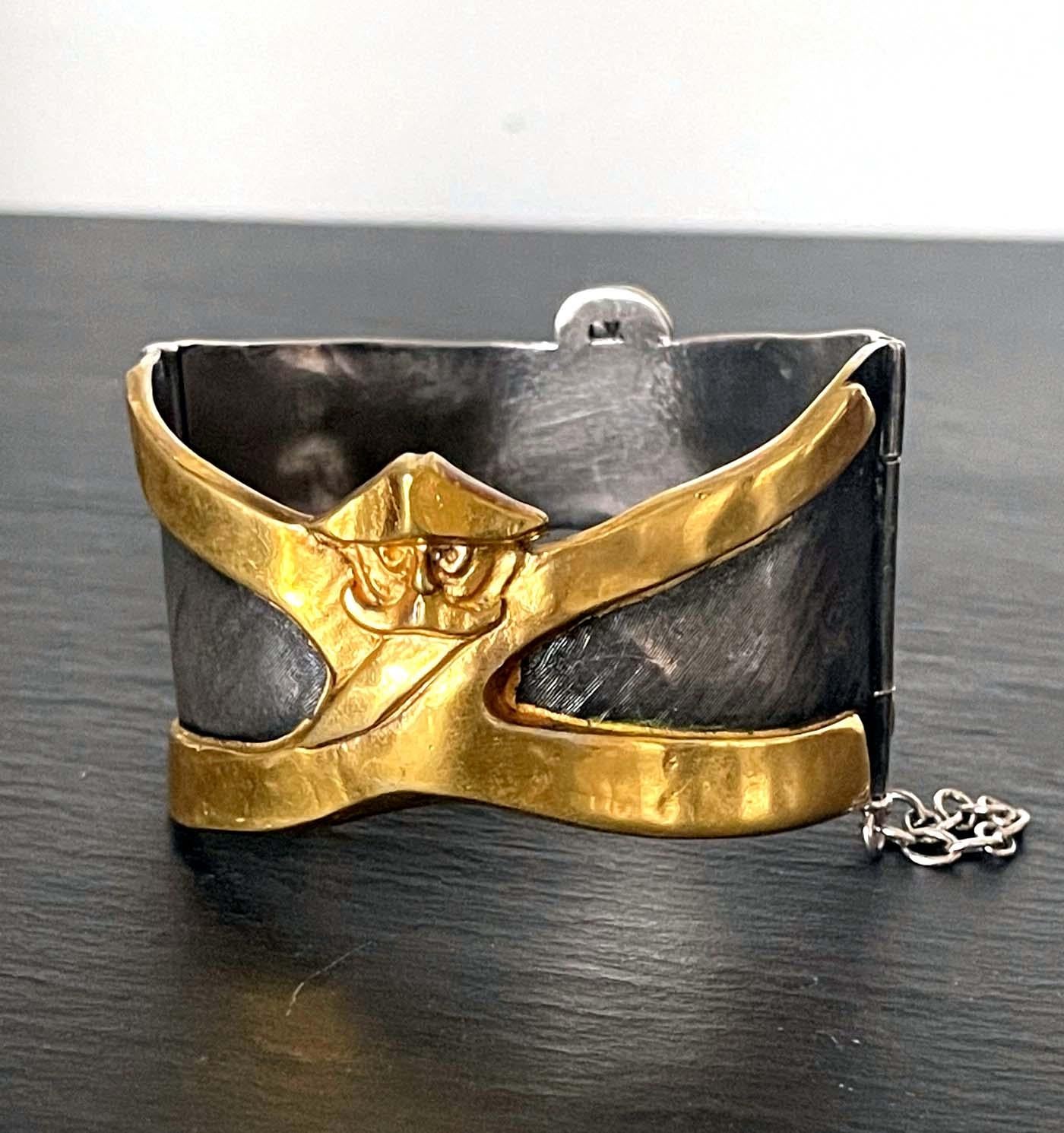 A rare cuff bracelet in gilded and silvered bronze by Parisian art jewller Line Vautrin (1913-1997). The playful piece is called 