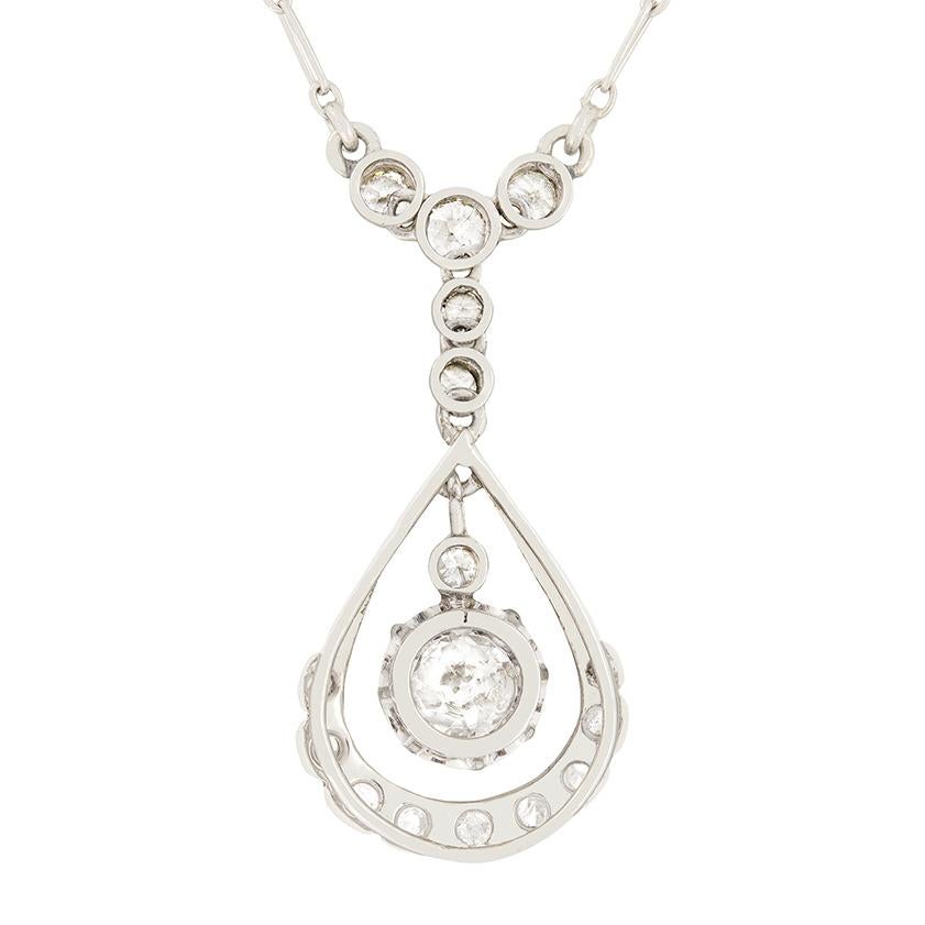 Beautifully designed is this French Art Deco platinum diamond drop necklace. The main focal point of this necklace is the larger diamond, weighing 0.80 carat, which dangles at the bottom with a small 0.05 carat diamond rub over set just above it. It