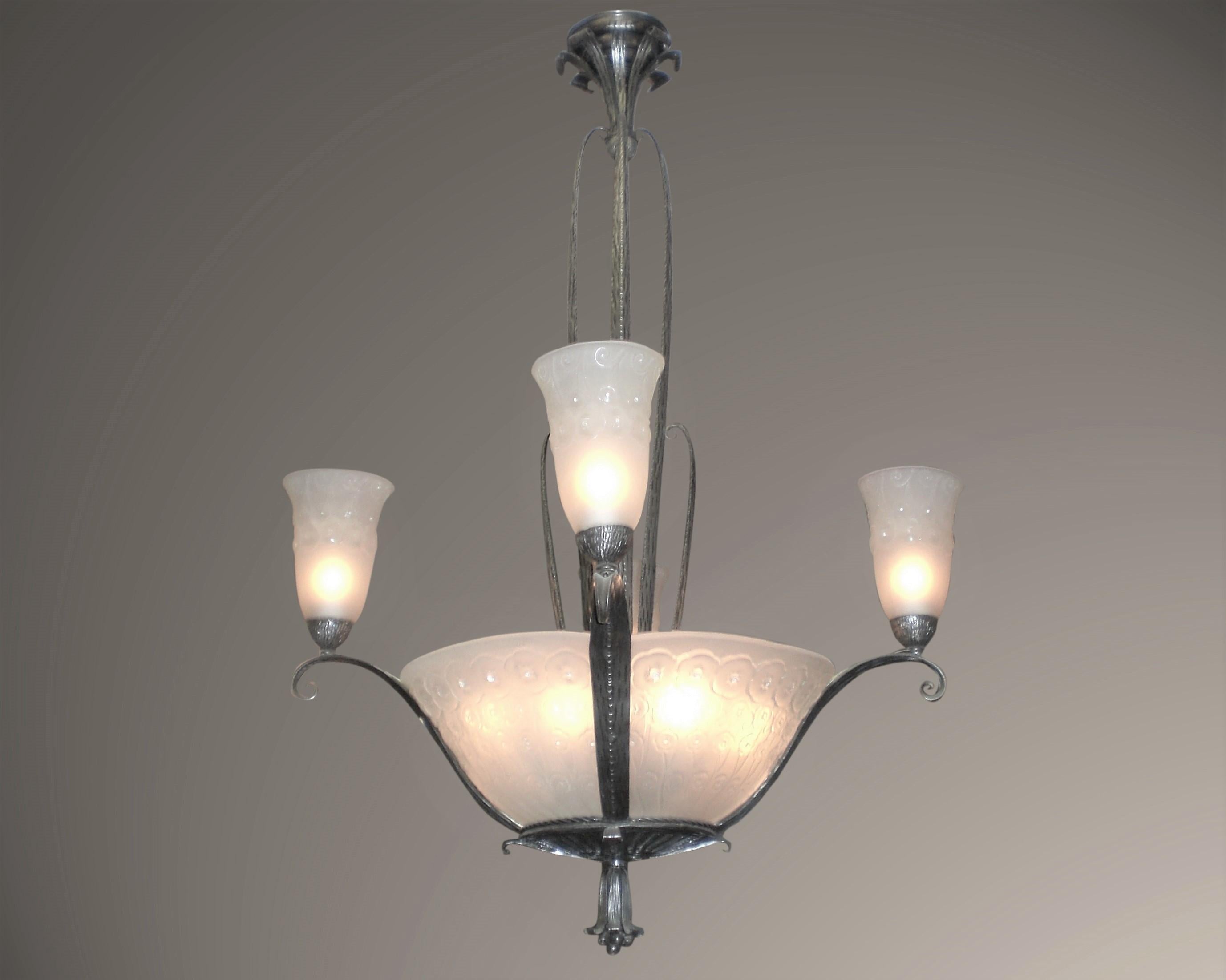 Fine and elegant French Art Deco chandelier. Four panels and four matching tulips mounted in the original hand-hammered iron armature with tiered waterfall scroll stem and delicate mount ending in a blossoming tulip finial. The frosted art glass