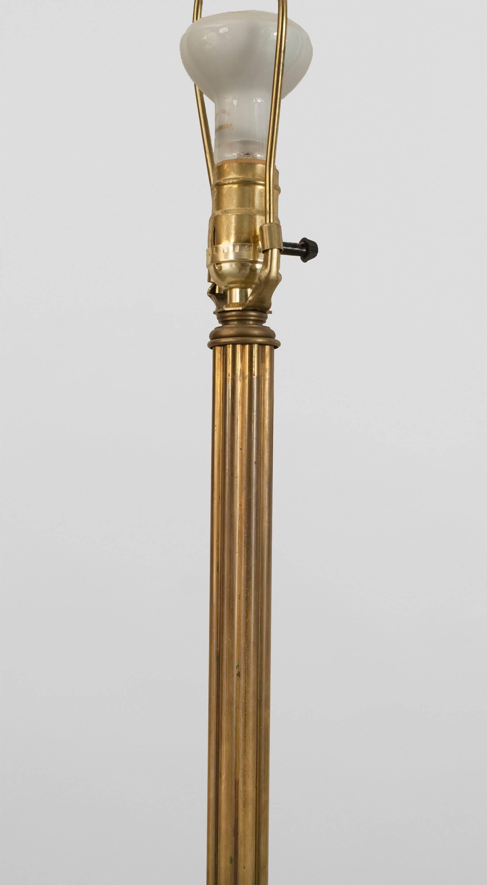 French Art Deco (1930s) bronze floor lamp with a fluted cylindrical shaft raised on 3 scroll form feet.
