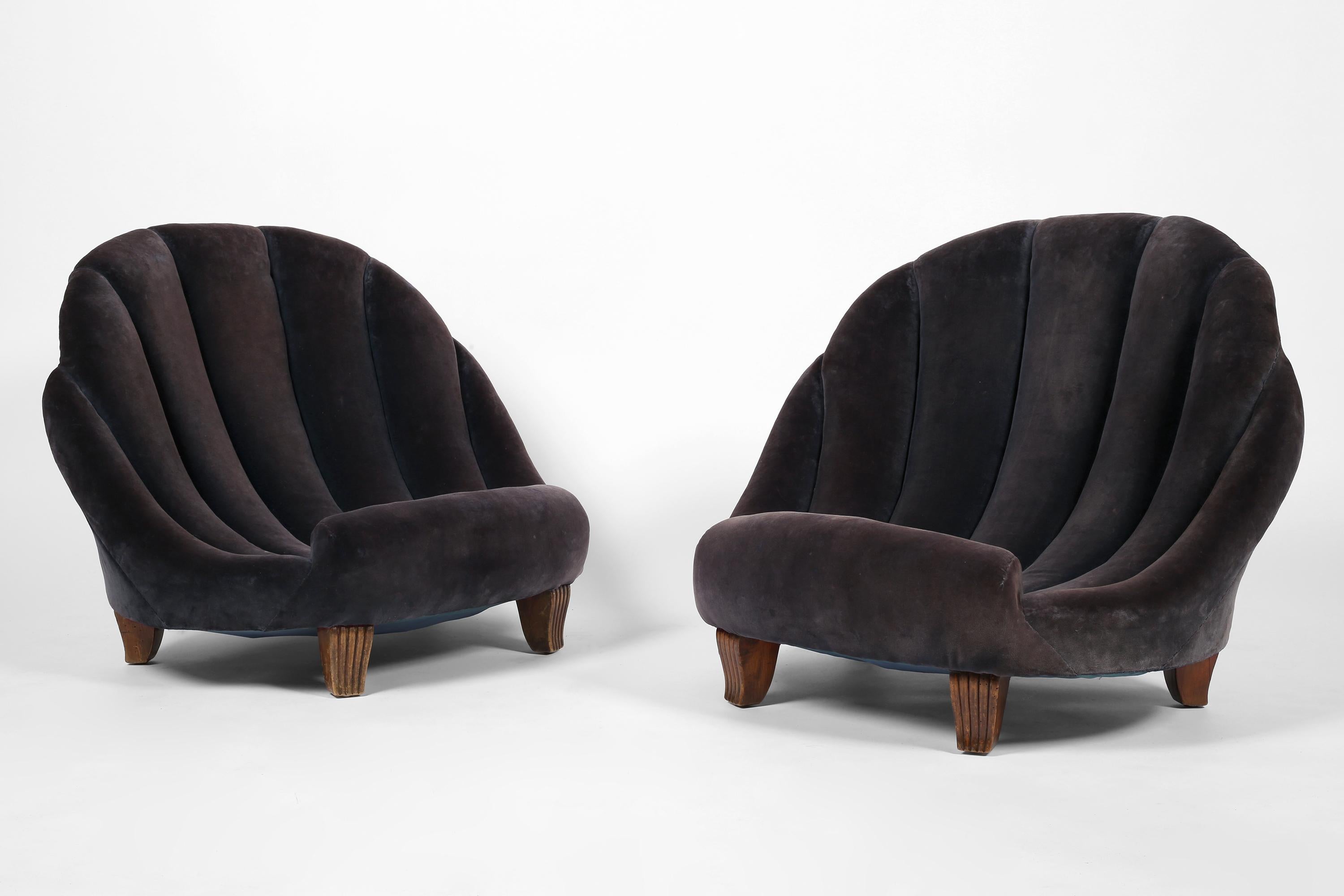 A pair of rare fireside chairs of surrealist, scallop shell-like form, likely commissioned by a prominent decorator of the Art Deco era and very much in the manner of Syrie Maugham (1879-1955) or Elsie de Wolfe (1865-1950).

Traditionally built and