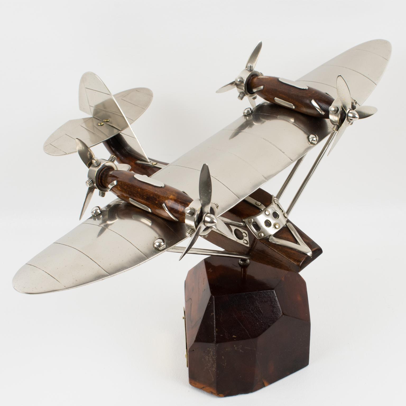 A fantastic French Art Deco chrome and wood airplane/seaplane model mounted on a stylized wood plinth. A superbly crafted rendering of the legendary quadri-propellers seaplane, strikingly evocative of a golden age in air travel. This handsome 1940s