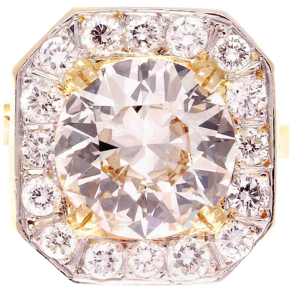 A magical dream that evolved into reality from the golden art deco era of jewelry. Featuring a 3.05 carat old European cut diamond that is K color, SI1 clarity. Surrounded by a celestial halo of old cut diamonds. Hand crafted in platinum and 18k