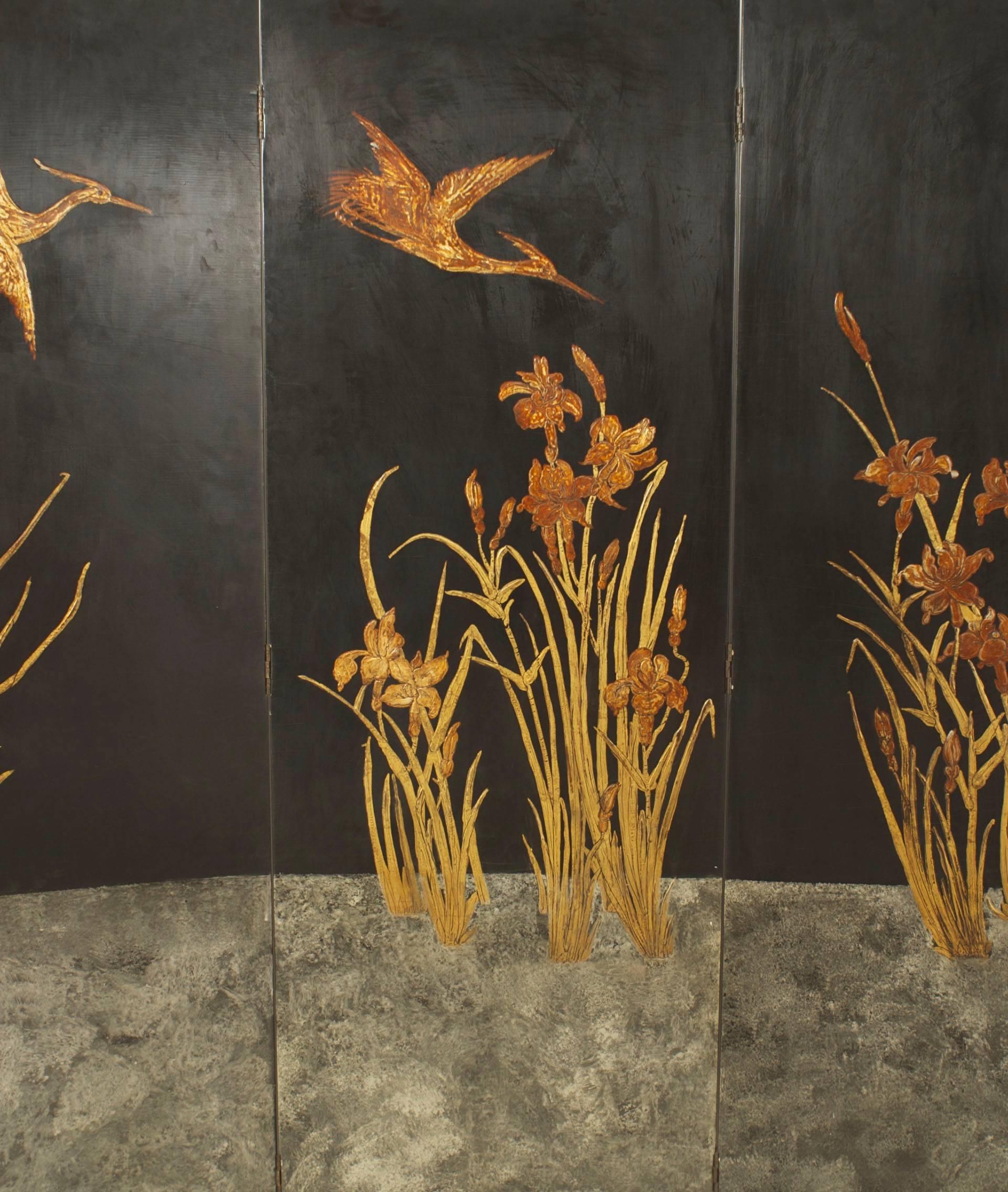 French Art Deco four fold screen decorated with a raised gilded scene of flying cranes and lilies in a silver gilt water landscape.
 