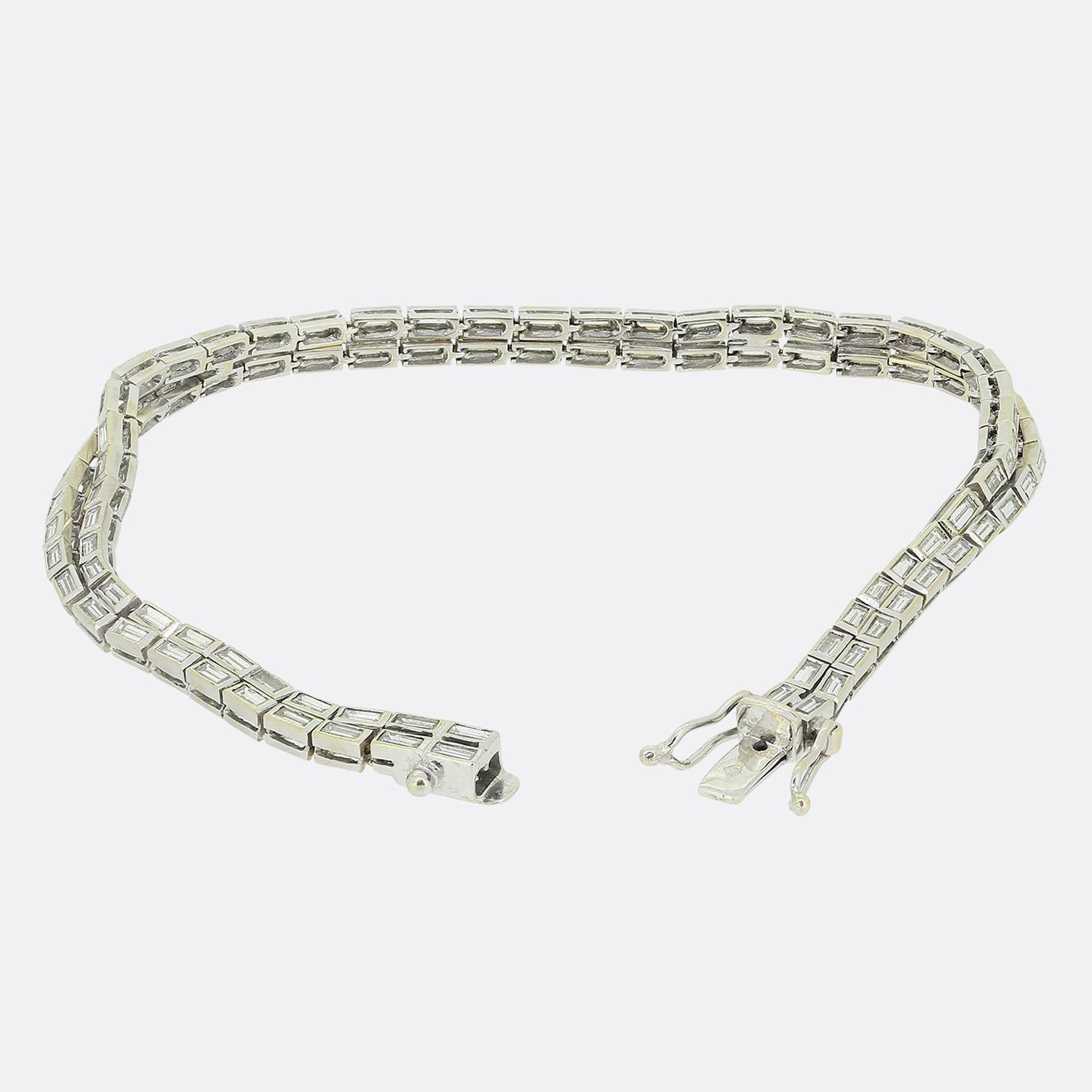 Here we have a stunning piece crafted in France at a time when the Art Deco style was continuing to revolutionise the world of design. This 18ct white gold bracelet showcases two rows of straight baguette cut diamonds atop of one another in a single