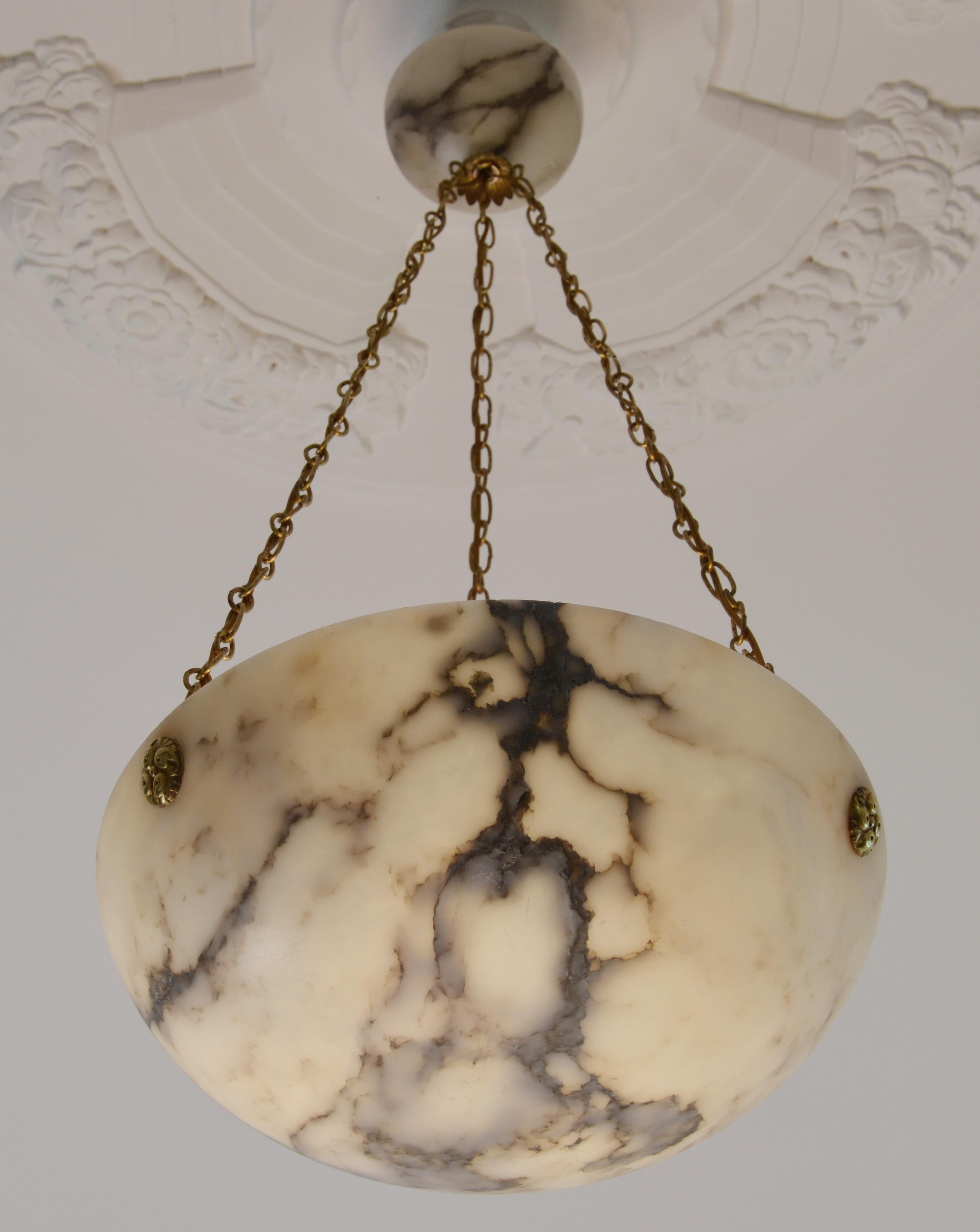 Any fair offer will be examined with the utmost attention, please send a message. French Art Deco pendant chandelier, France, 1920s. Alabaster and brass. Thick alabaster shade hung on its original fixture. Canopy made of alabaster. Brass
