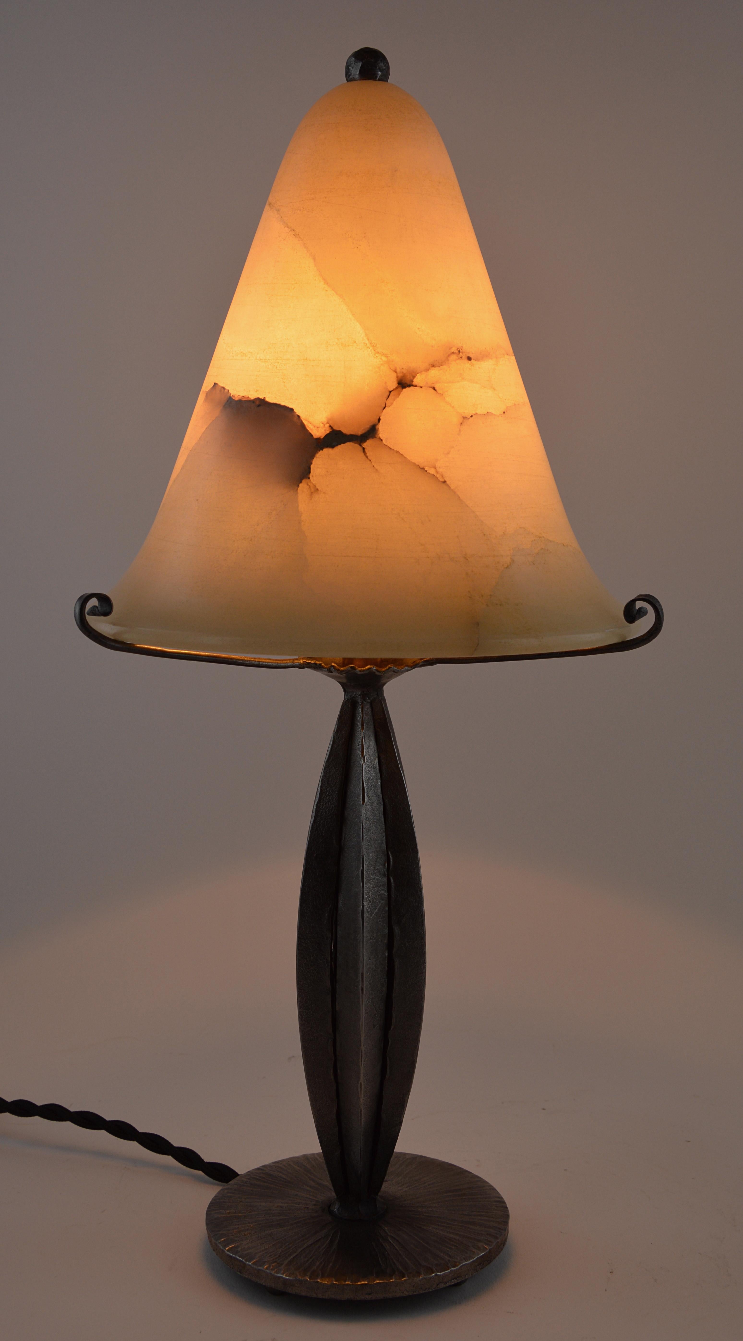 French Art Deco table lamp, France, 1920s. Wrought-iron base. Alabaster shade. Old alabaster cannot be compared to new ones. Old alabaster has veins. Sometimes they can be mistaken for cracks. But they are not cracks, they are veins. Measures: