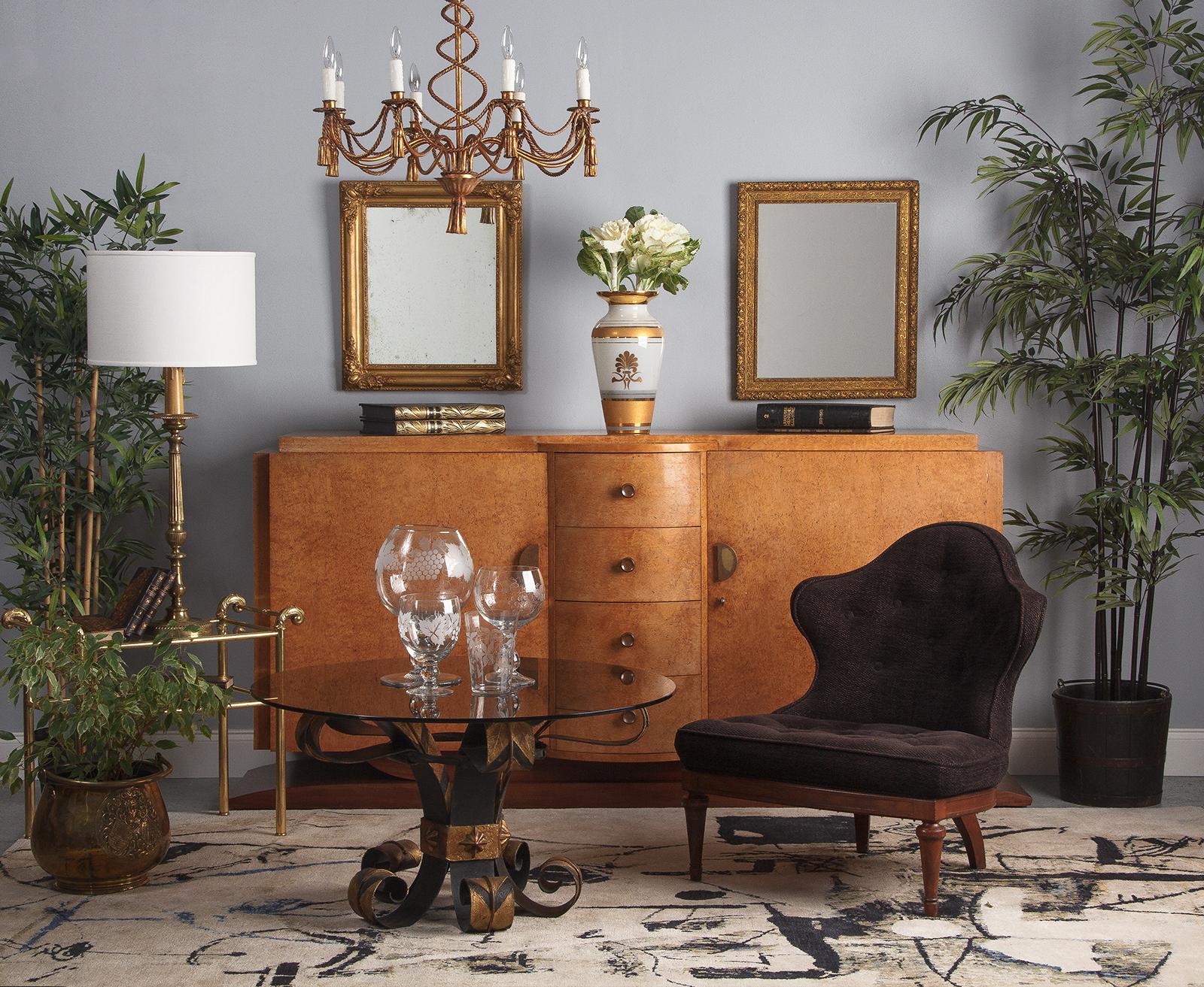 A striking French Art Deco buffet in burl amboyna wood, circa 1930. The gorgeous, exotic amboyna burl wood is light in tone, making the large piece feel light and bright. It rests on a classic Art Deco mahogany base, with a curved edge plinth foot