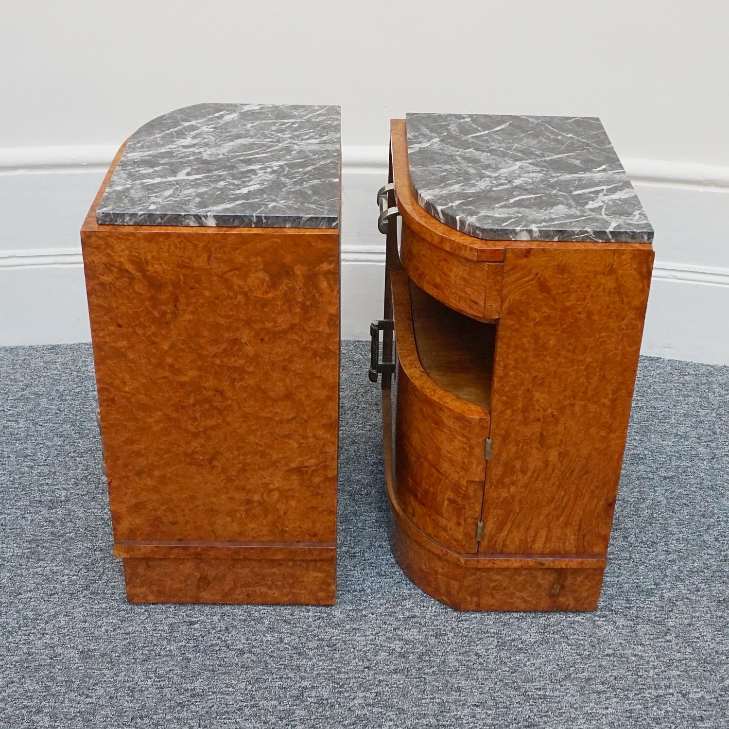 A pair of Art Deco bedside cabinets. Burr Amboyna veneered curved bedsides with lower cupboard, middle shelf and upper drawer. Original marble top with original metal handles. 

Dimensions: H 67cm W 48cm D 34cm

Origin: English

Date: Circa
