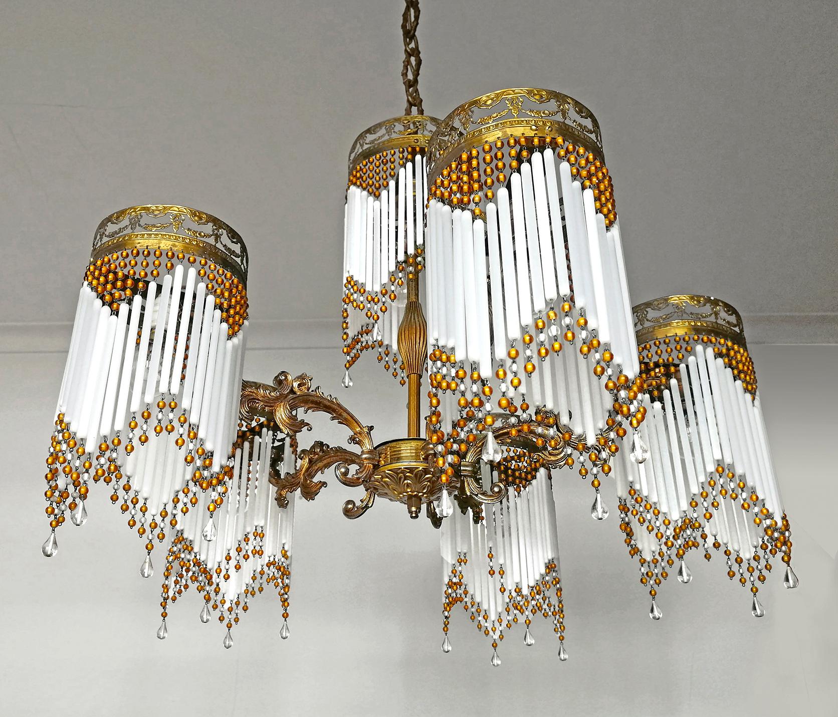 Gorgeous antique French chandelier in beaded opaline glass tubes, Art Deco / Art Nouveau, circa 1920.
Measures:
Height 45.28 in. (chain 17.71 in.)/ (115 cm (chain 45cm))
Diameter 27.56 in. (70 cm)
7-light bulbs E14/ good working