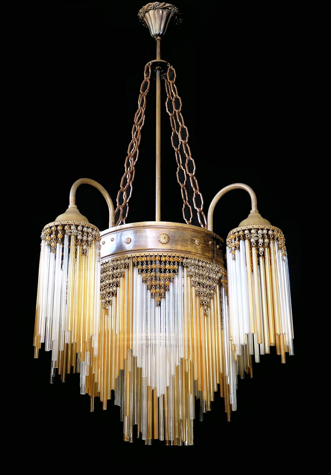 Fabulous antique Art Deco or Art Nouveau chandelier in clear and amber beaded glass.
Measures:
Diameter 22 in / 55 cm
Height 38 in / 95 cm
7 light bulbs E14/ good working condition.
Age patina.
Assembly required. Bulbs not included.