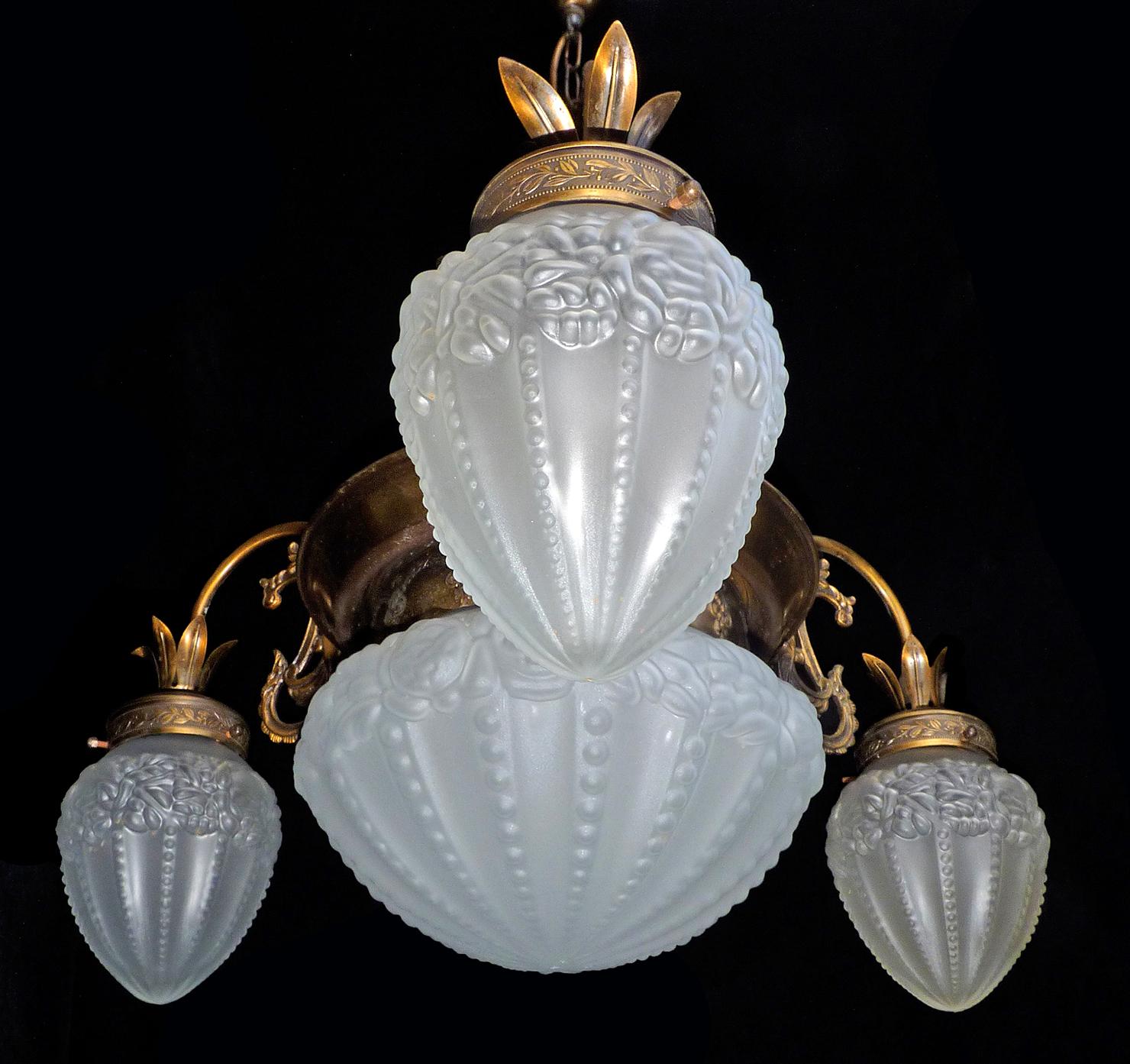 French Degué style Art Deco white frosted glass, 4-light brass chandelier/ gold and bronze color metal with patina.
4 bulbs E14
Good working condition 
Measures: Diameter 28.5 in / 72 cm
Height 32 in / 80 cm
Glass shades: 6 in (15 cm) / 8 in (20