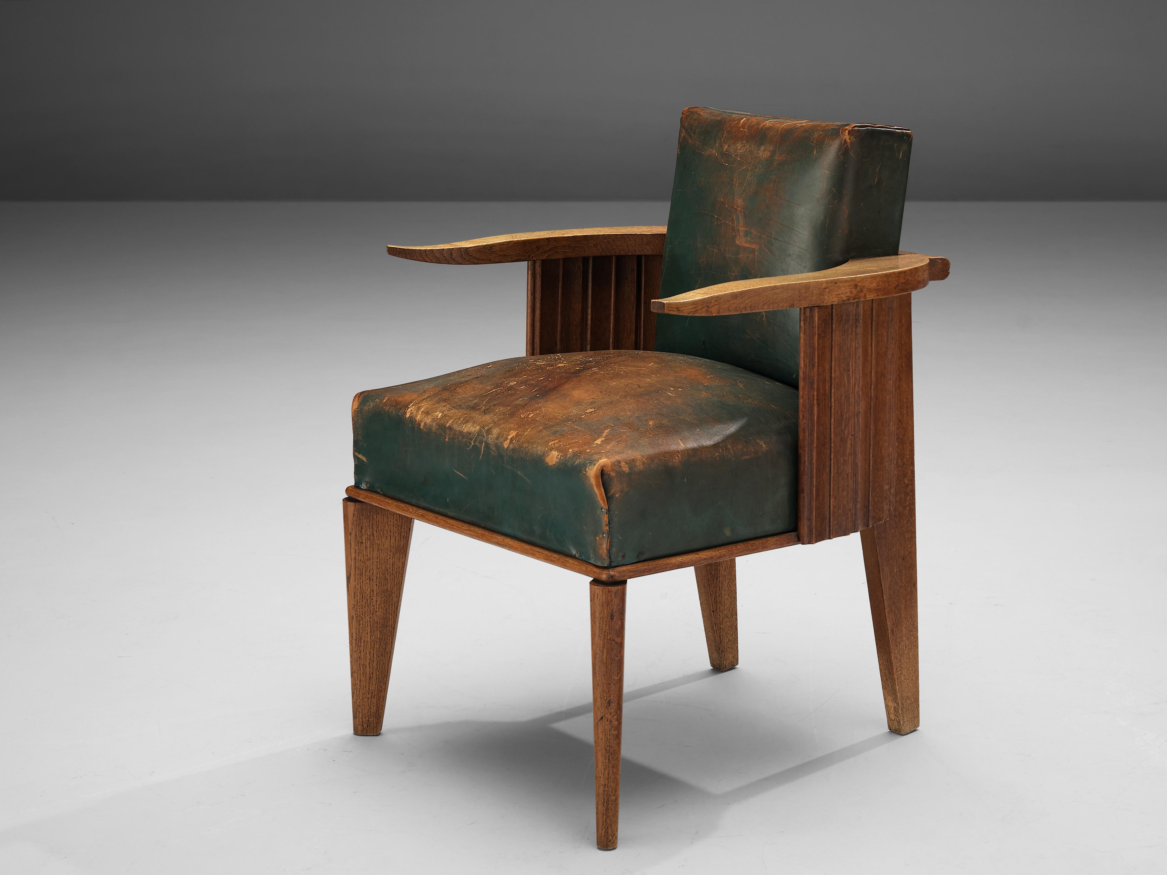 Easy chair, wood, patinated green leather, France, 1920s

This unique design features cow horn-shaped armrests, thick cushions and carved, closed sides. The two legs in the front of the chair are slightly turned to the side creating a dynamic