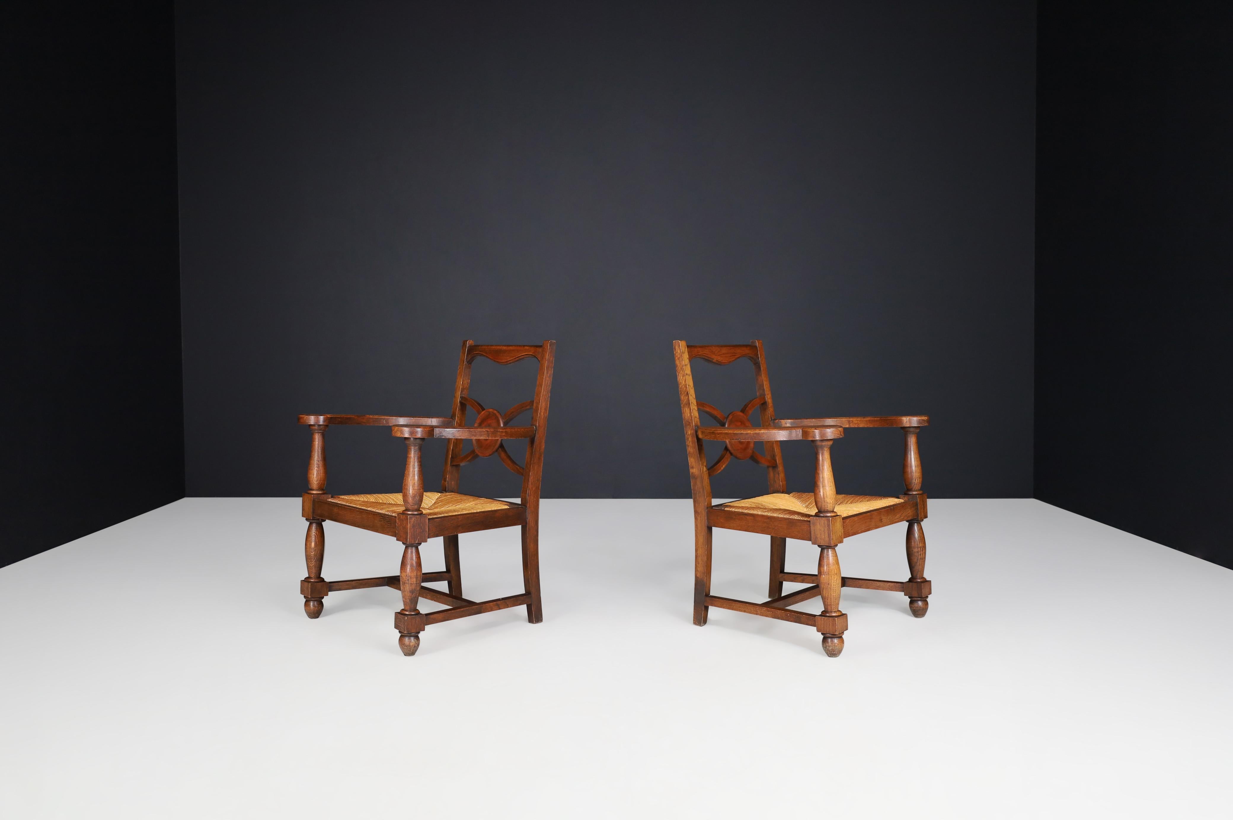 French Charles Dudouyt Attr. Patinated Oak and Rush Armchairs, France 1940s For Sale