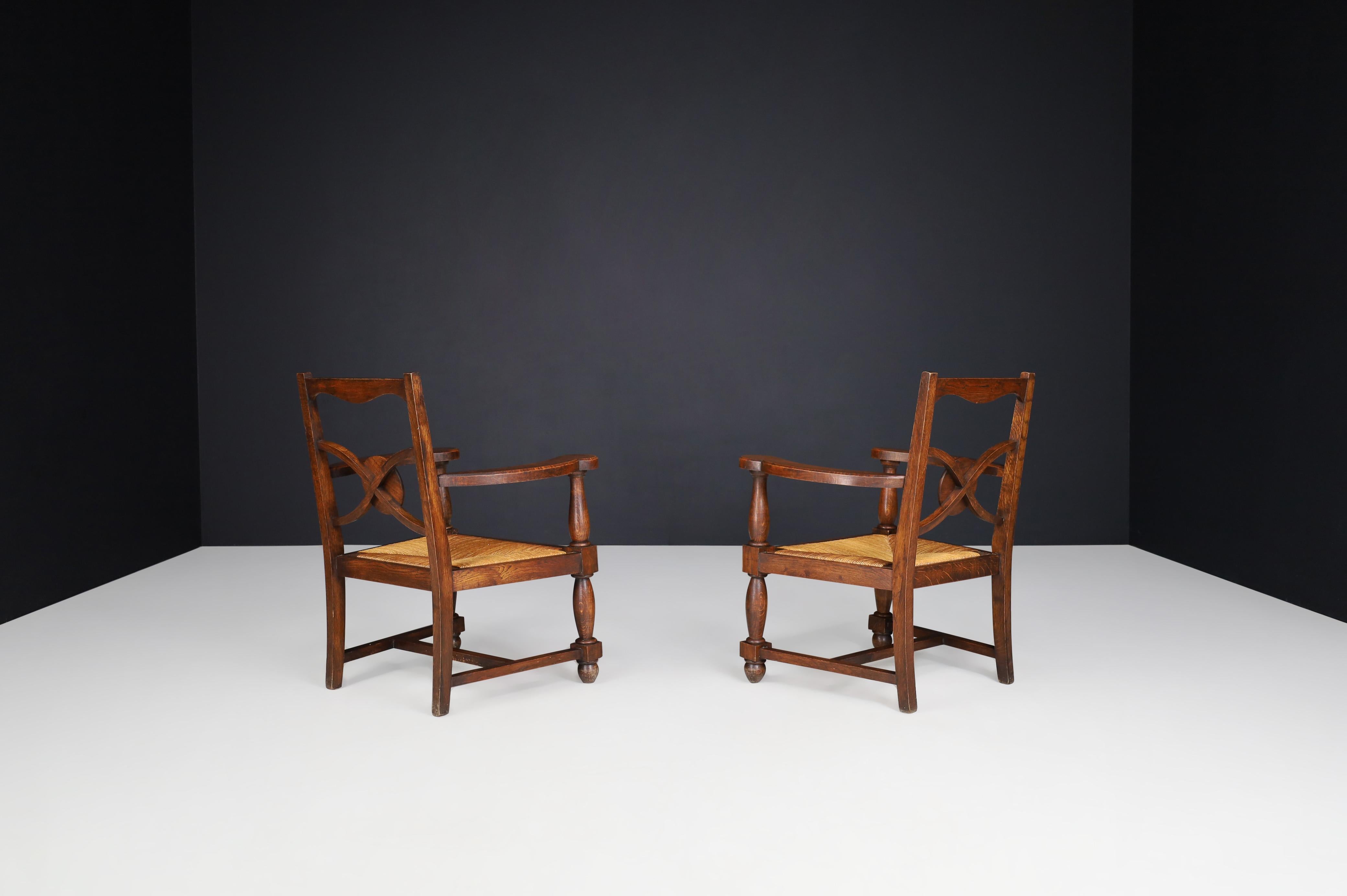 Charles Dudouyt Attr. Patinated Oak and Rush Armchairs, France 1940s In Good Condition For Sale In Almelo, NL