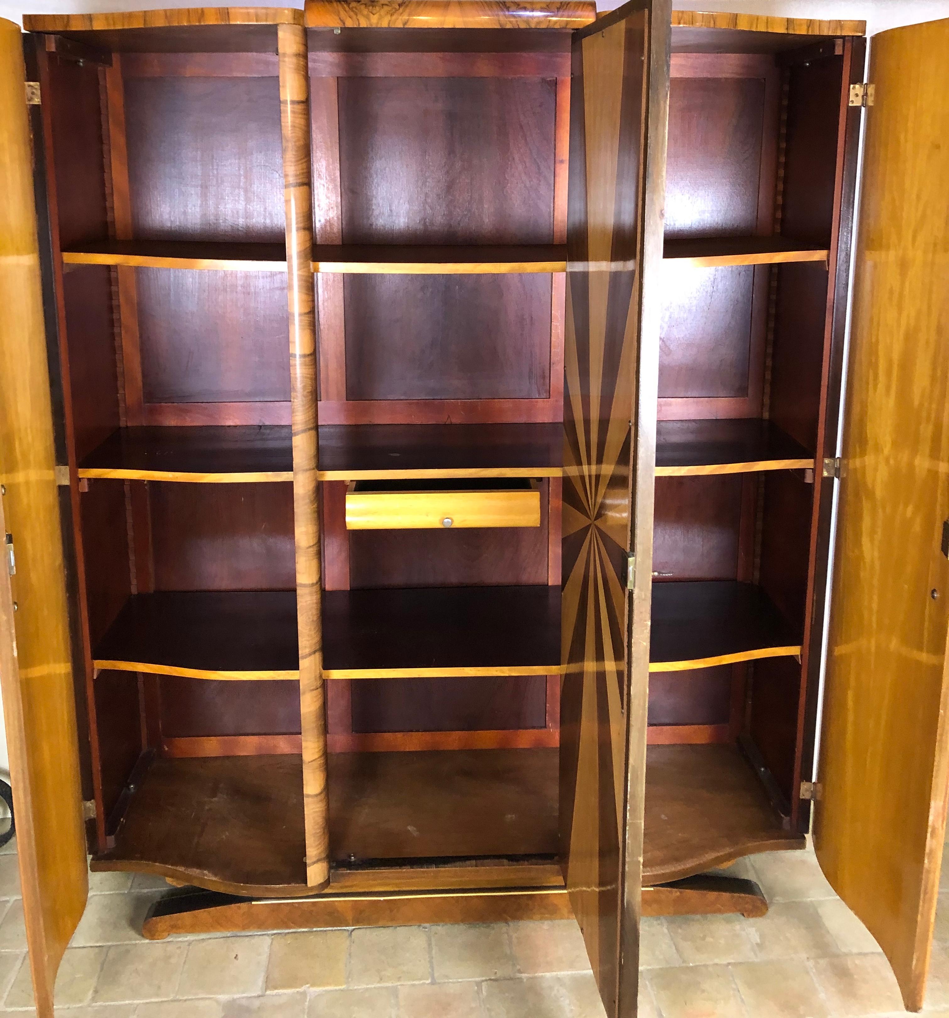 Beautiful quality French art deco armoire constructed of walnut with adjustable shelves. Original nickel plated brass hardware.

This piece is very practical in a bedroom or as a display cabinet when the mirror is removed and replaced with clear