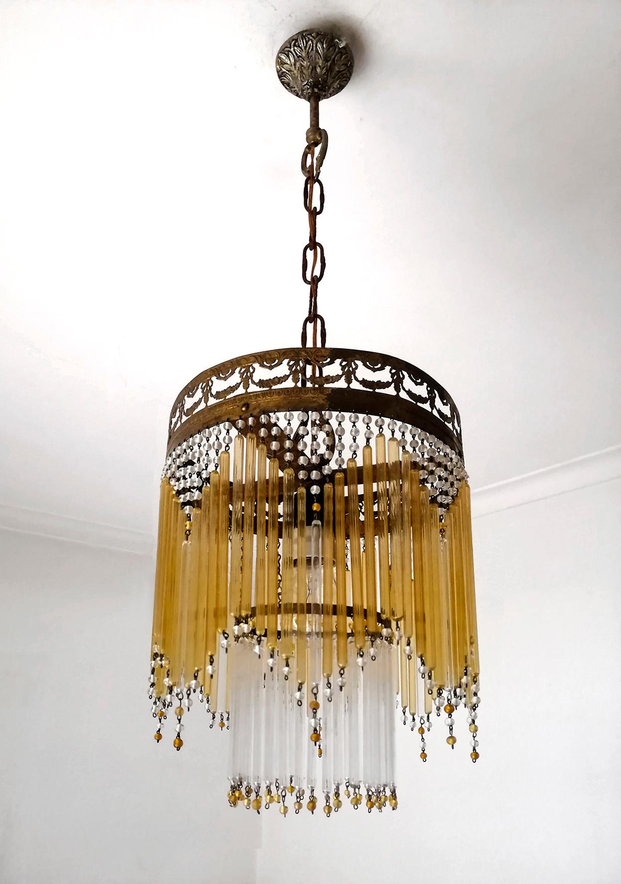 Antique French chandelier in amber beaded glass tubes, Art Deco / Art Nouveau.
Dimensions
Height 27.56 in. (chain = 10 in.) /70 cm (chain = 25 cm)
Diameter 9.85 in. (25 cm)


1-light bulb E27/ good working condition
Assembly required. Bulbs