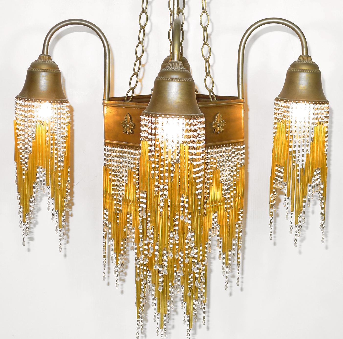 Fabulous midcentury in clear and amber beaded glass Art Deco or Art Nouveau chandelier.
Measures:
Width: 16 in / 40 cm
Diagonal: 20 in / 50 cm
Height: 38 in / 96 cm
Five light bulbs E14/ good working condition/European wiring.
Age patina.