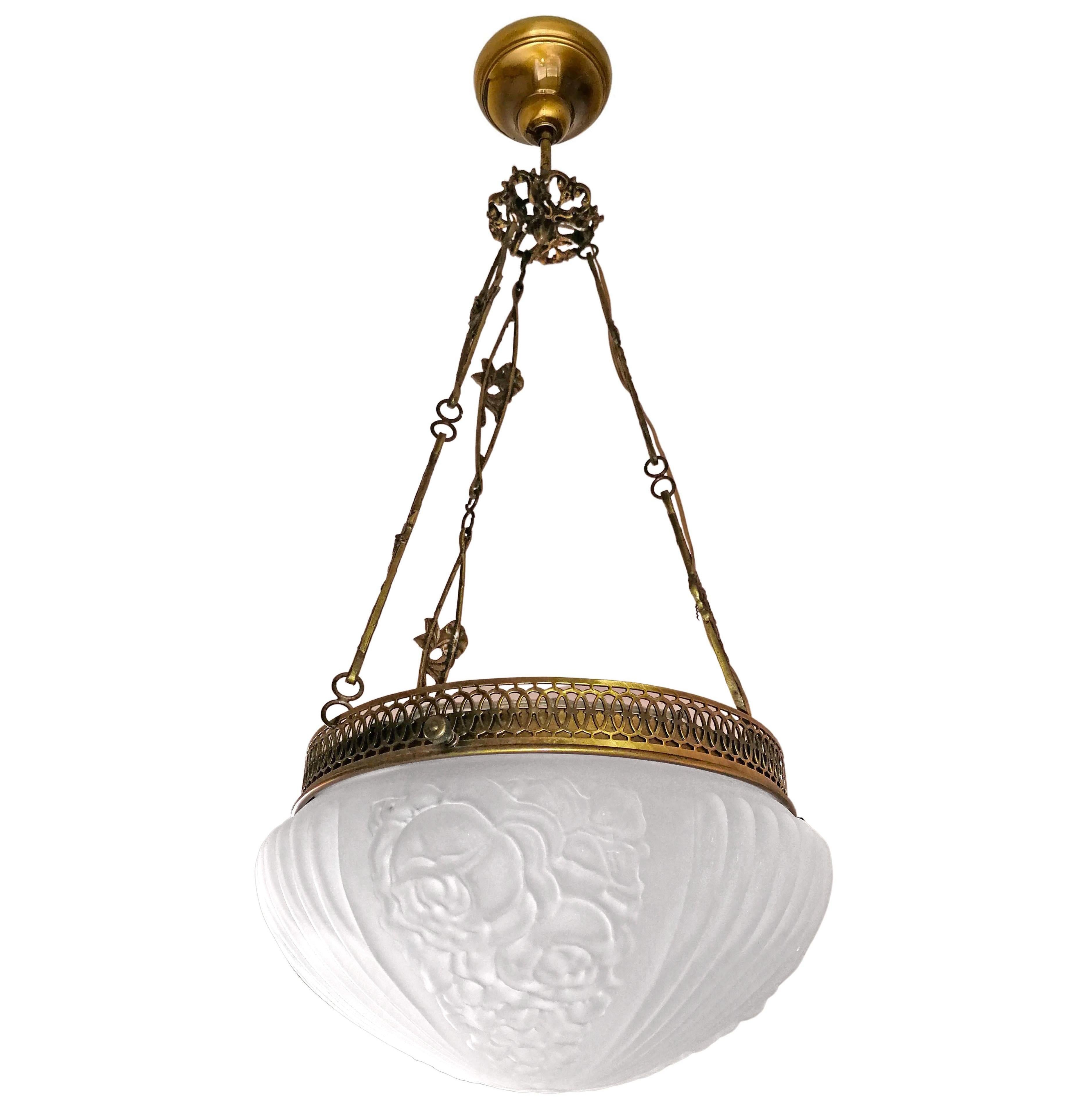 Gorgeous French Art Deco and Art Nouveau in frosted glass chandelier. Engraved gilt bronze and gilt brass trim. Age patina
Dimensions
Height: 33.50 in. (86 cm)
Diameter: 14.18 in. (36 cm)

Two light bulbs E27
Rewired/ Good working condition
Assembly