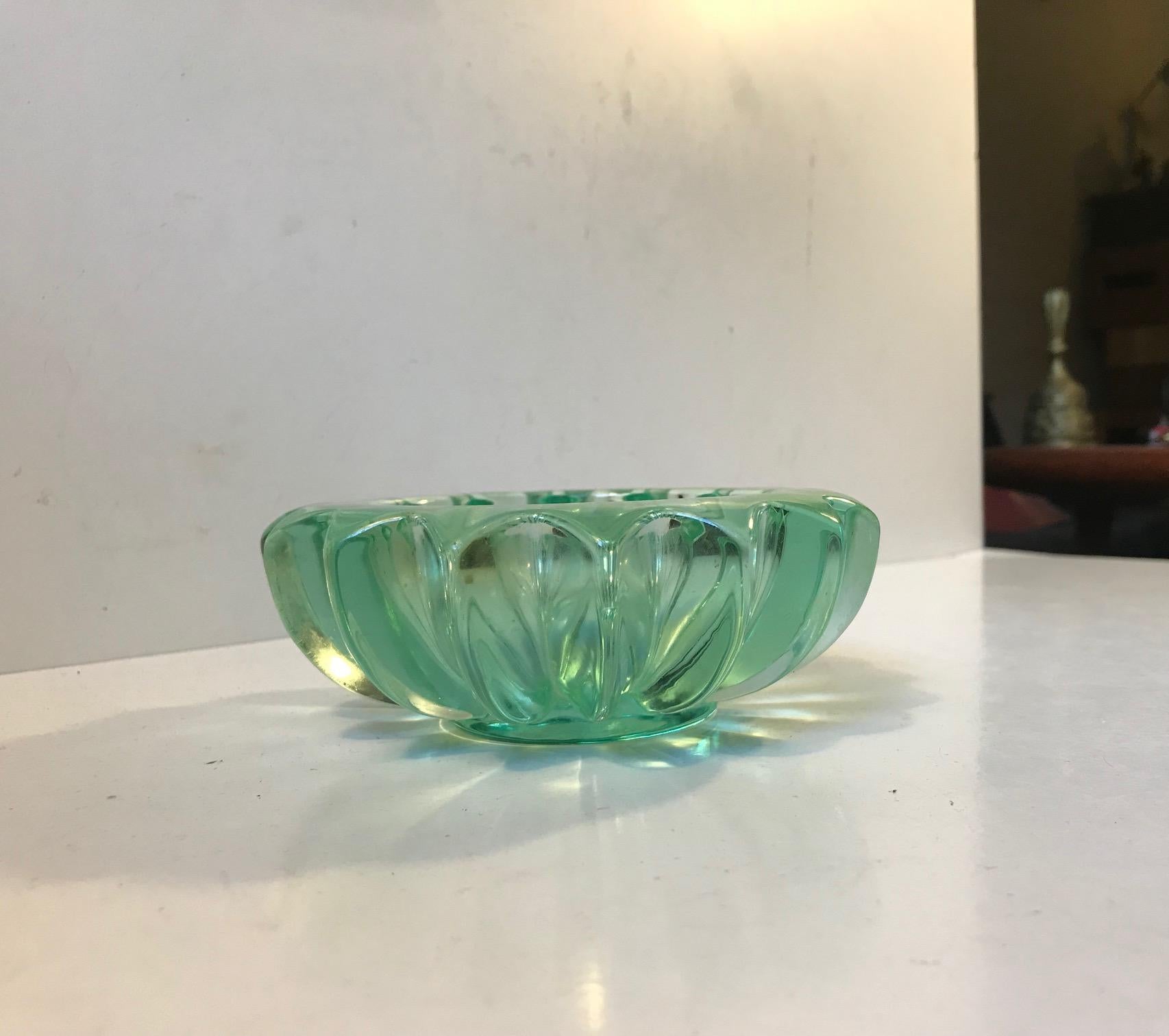 Thick glass dish or ashtray designed by Pierre D’avesn during the 1940s. It resembles a shooting star. Star-bottom shooting up through the body of the vase.