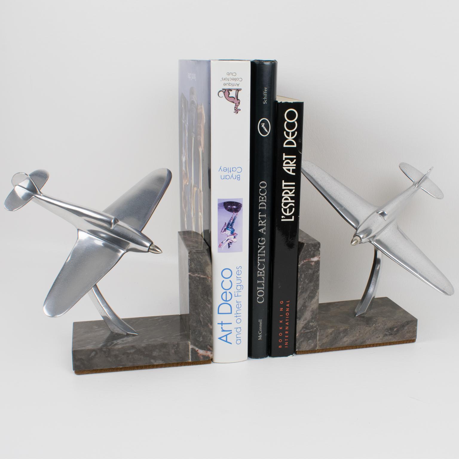 Elegant 1940s French Art Deco aluminum airplane models mounted on a marble plinth to built great-looking bookends. These nice sculptural model airplanes are made with cast aluminum. Standing on an 