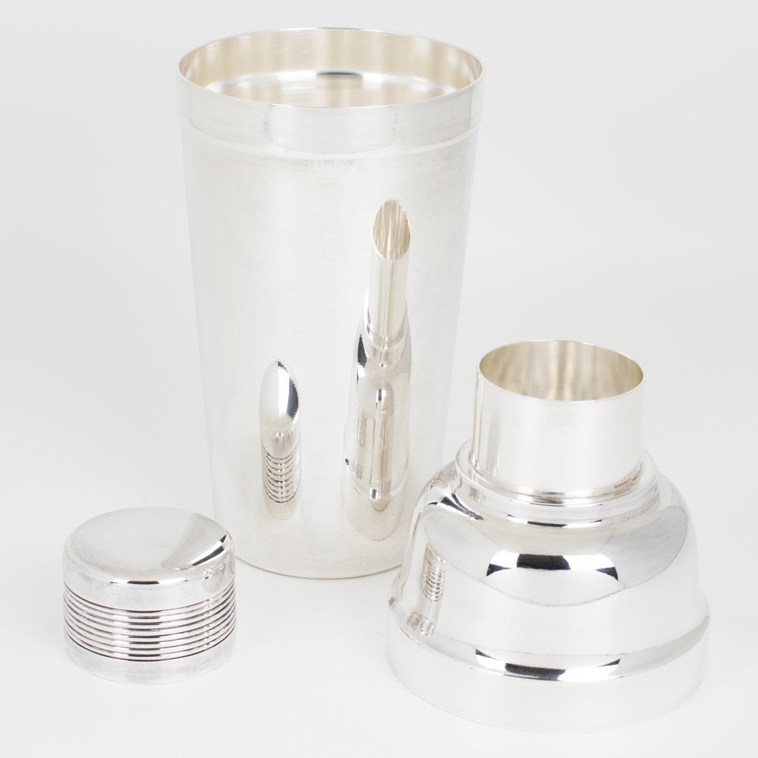This elegant French Art Deco silver-plated cylindrical cocktail or Martini shaker was crafted by silversmith Ercuis, Paris, circa 1940. The three-sectioned cocktail shaker has a removable cap and filter strainer. Lovely Art Deco flair with geometric