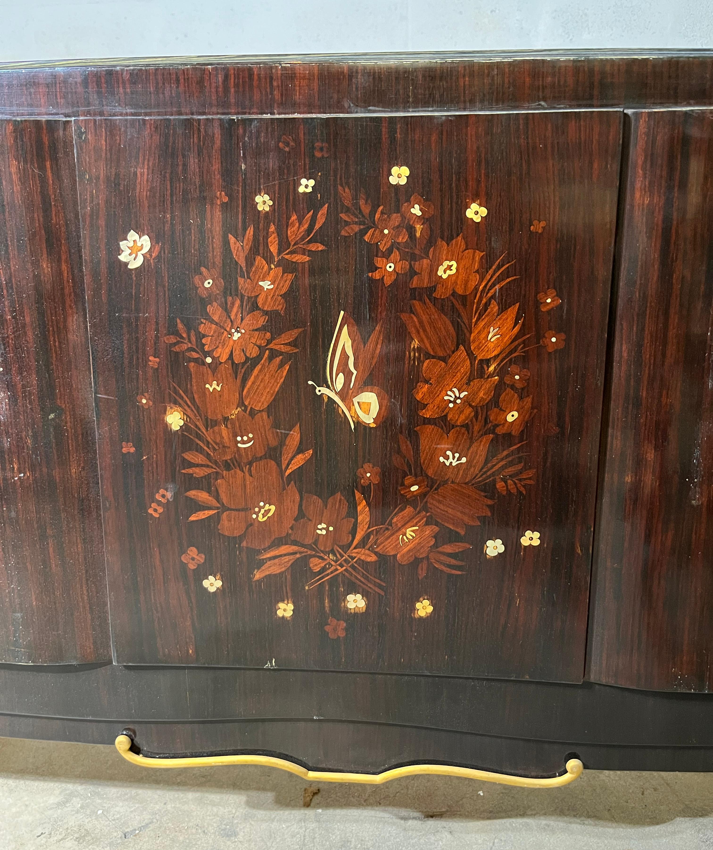 Rosewood Art Deco bed attributed to Jules Leleu, the bottom part inlaid figuring vegetal and butterfly.
Slightly curved lines with bronze accents.
Measures: 47