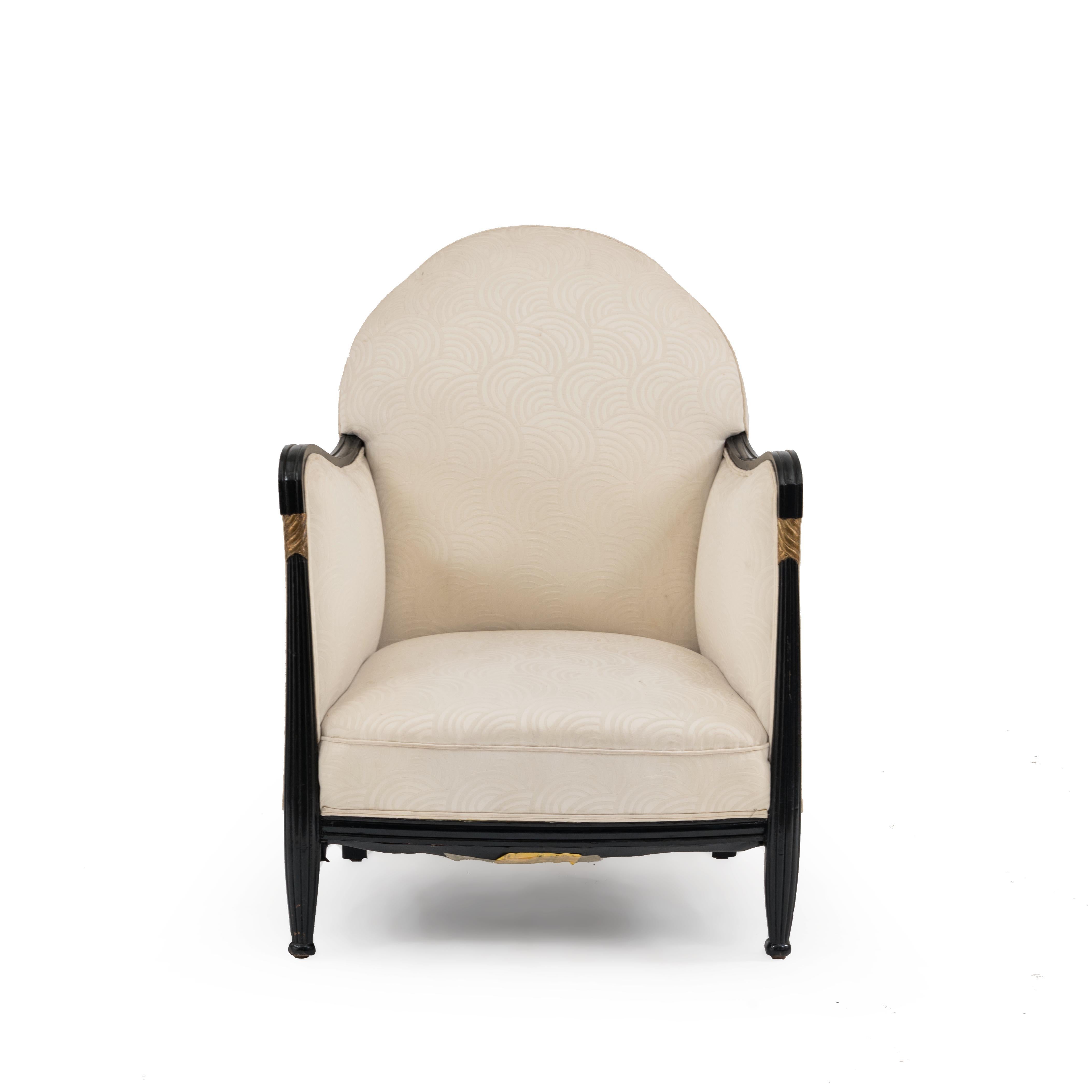 Pair of French Art Deco black lacquered and gilt trimmed bergère armchairs with white circle upholstery.