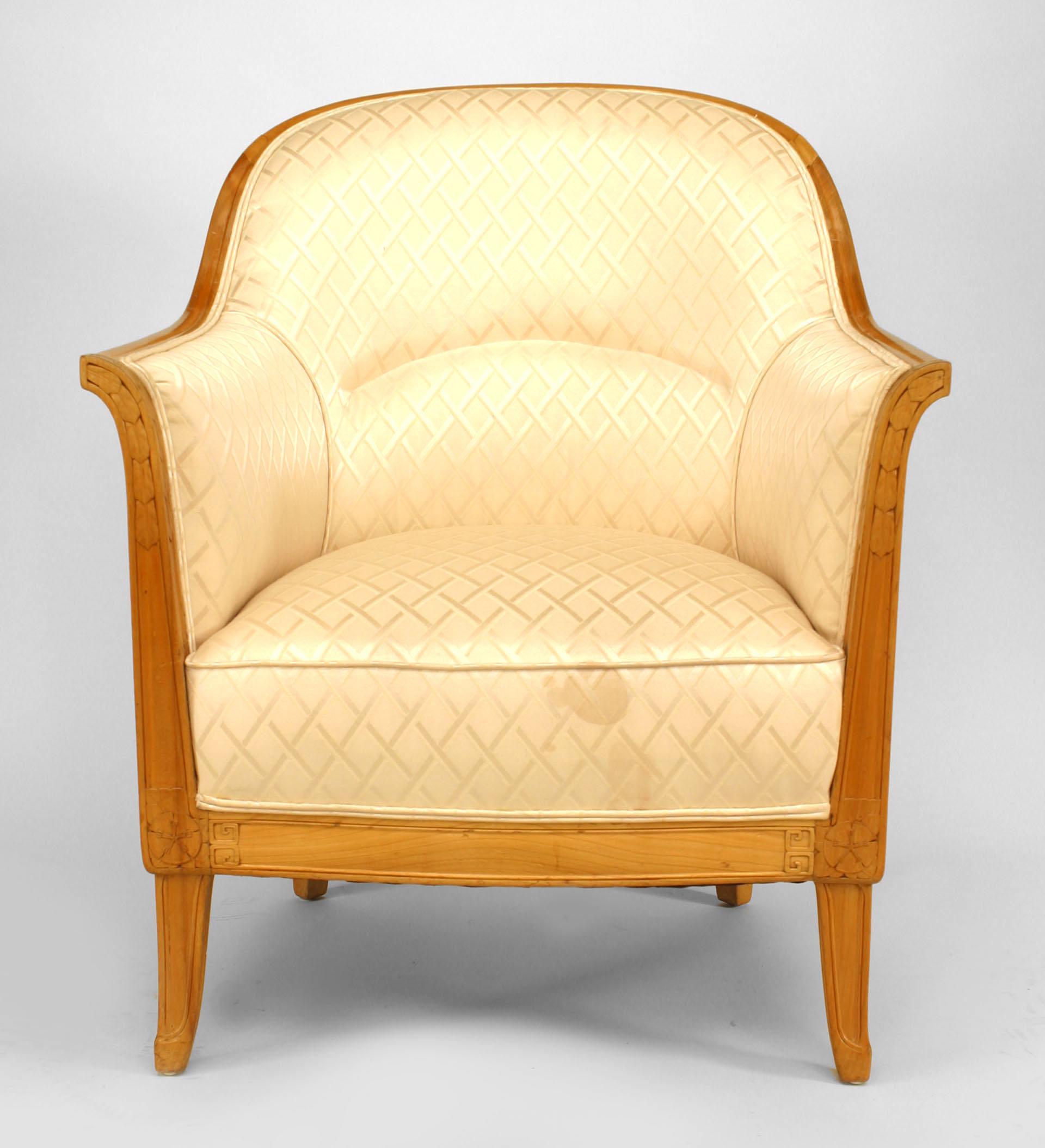 French Art Deco fruitwood bergere arm chair carved with leaf & rosette motifs and upholstered in beige silk. (Attributed to LEON JALLOT)
