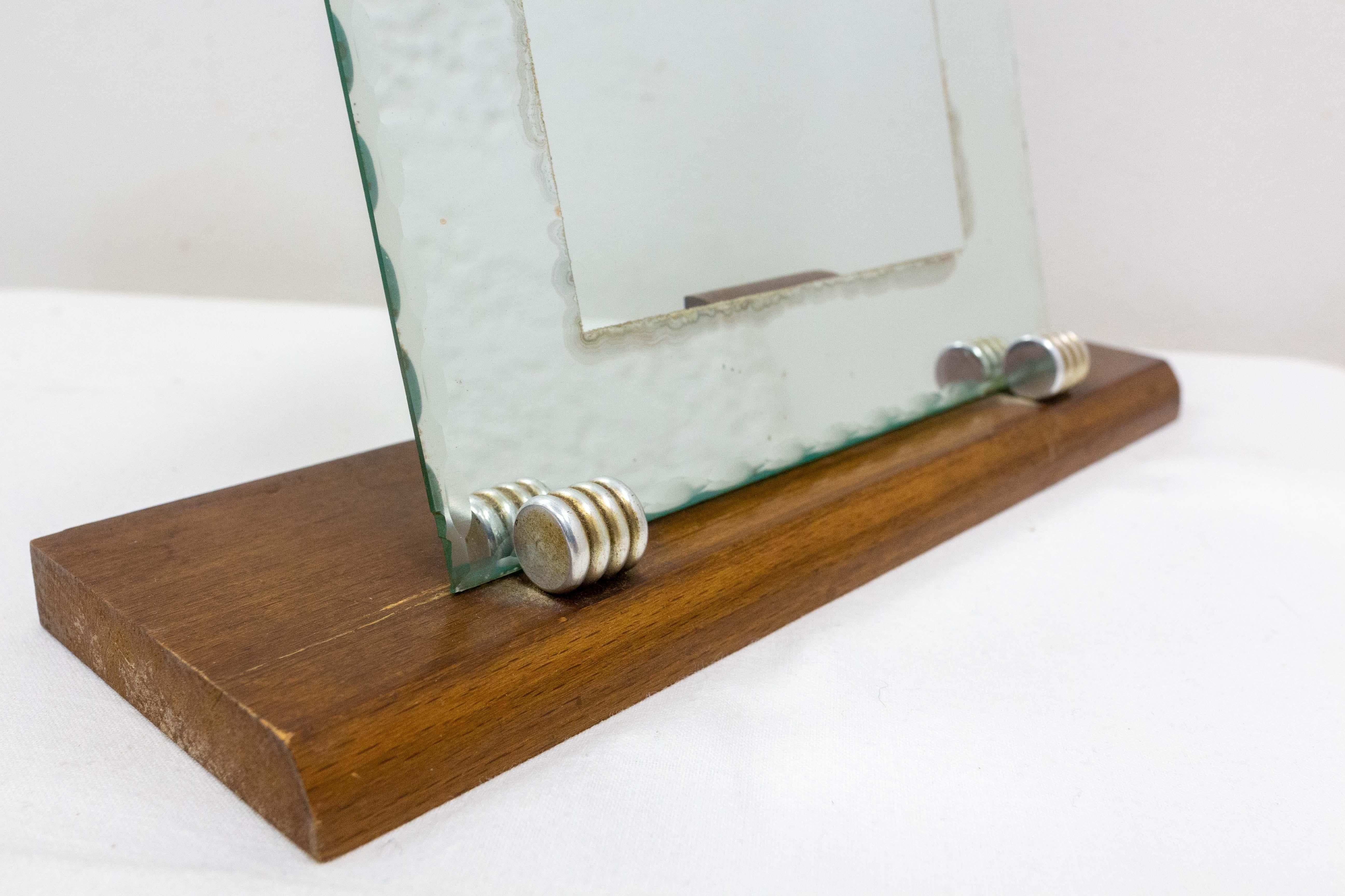Picture frame in beveled mirror and glass.
Beech base with two pieces of chrome and one piece of beech to maintain the frame up.
French, circa 1930.
Some signs of wear on the the frame, that make the charm of this antique piece.

Good antique