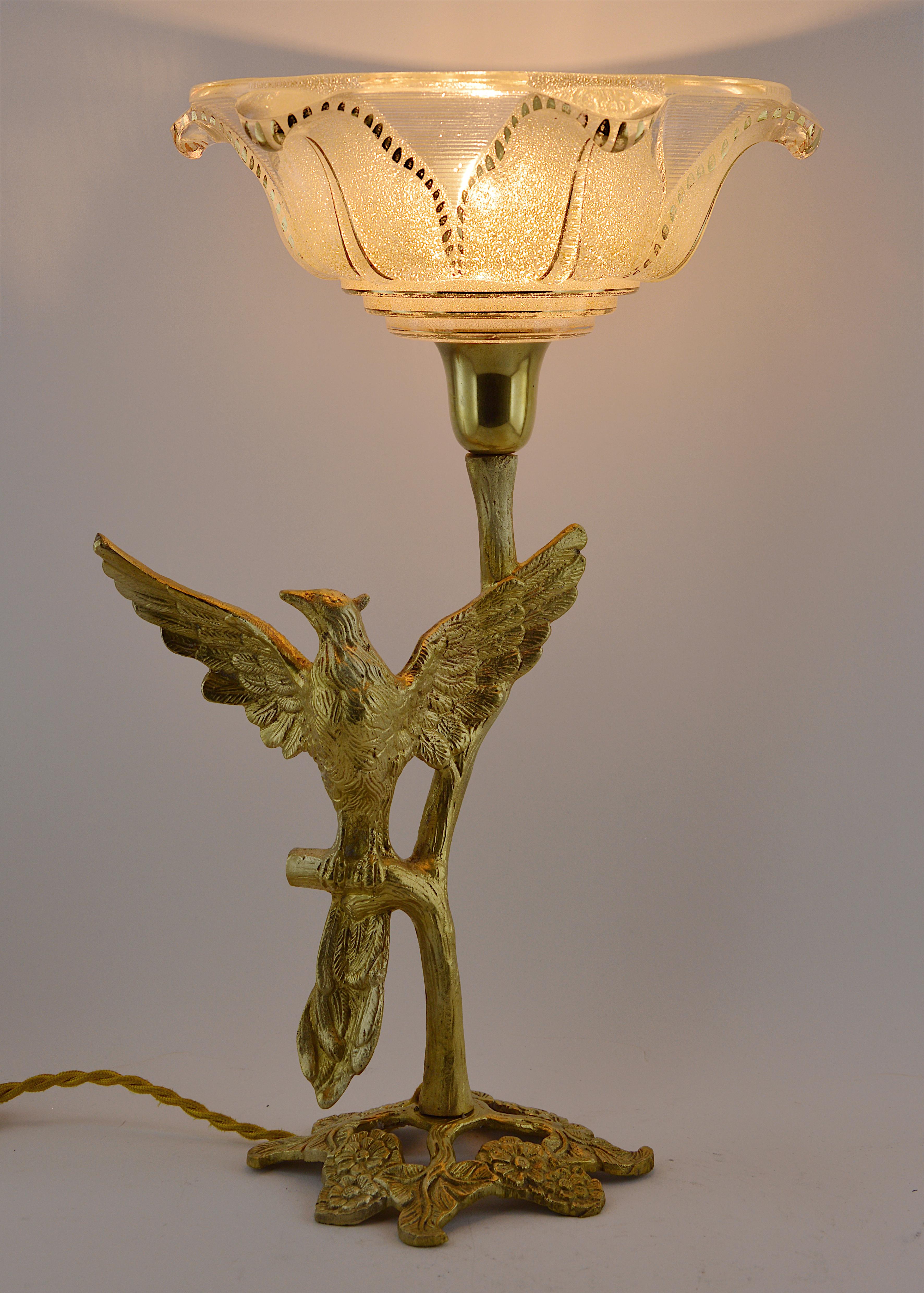 French Art Deco bird table lamp, late 1930s. Bronze paradise bird on a tree. Superb gilt frosted molded glass shade. Measures: Height 15
