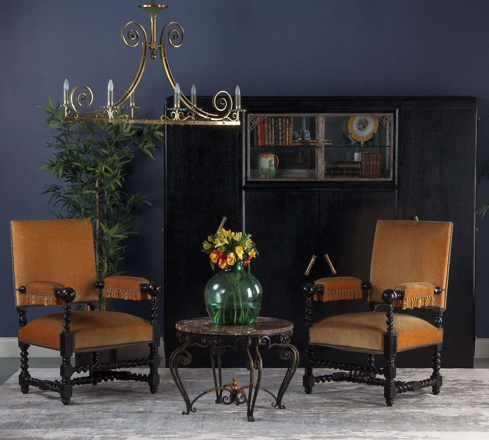 A stunning French Art Deco cabinet that was painted black with light grey interior. The piece was originally made in walnut veneer and is dated 1937 on the back of the mirror. The cabinet features four wooden doors with brass handles, paneled sides