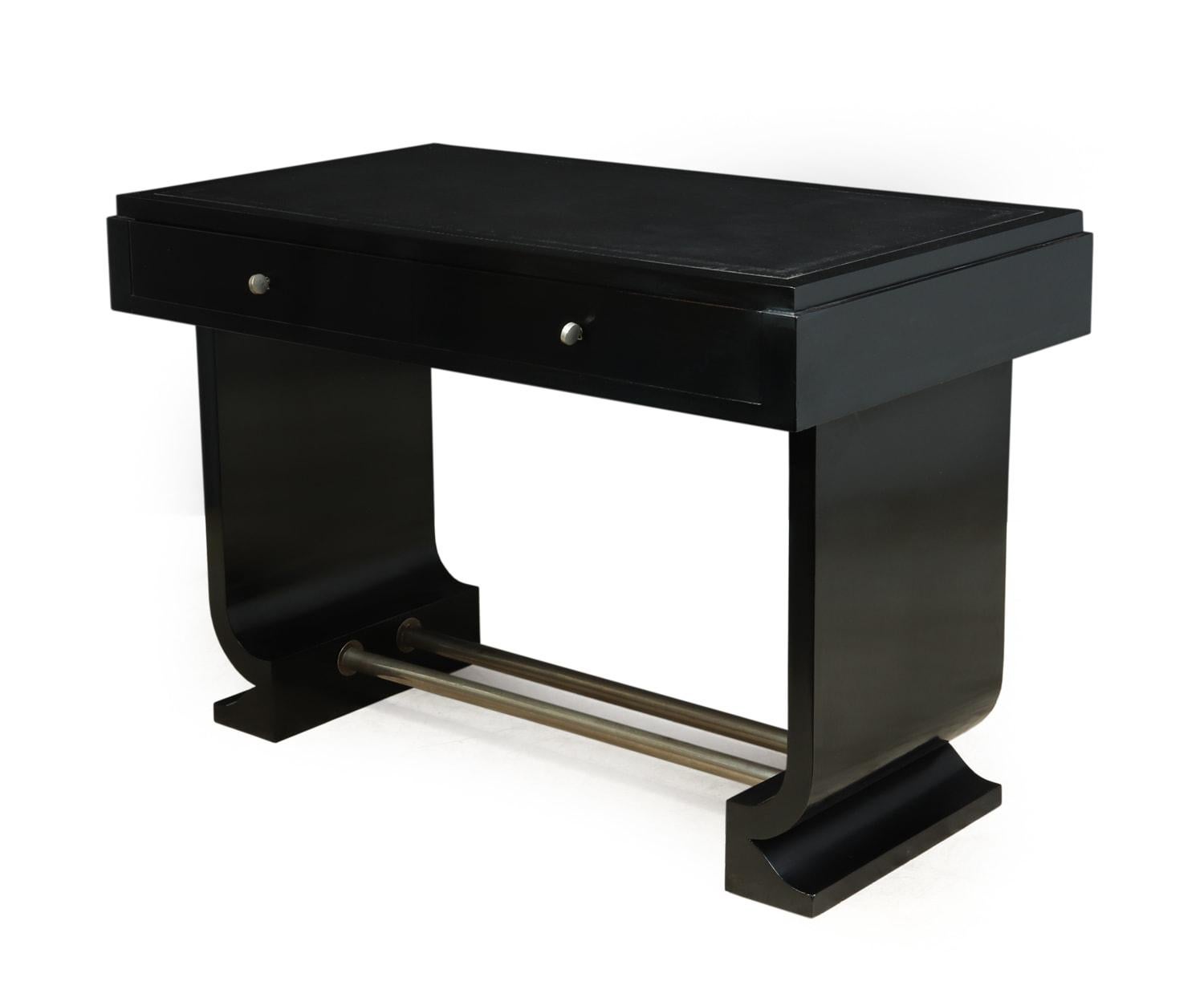 French Art Deco black desk circa 1930

This French two drawer desk or library table has an inset hyde leather top, and two lockable drawers, and a nickel plated double footrest with curved sides, the drawers run smoothly and have handcut dovetail